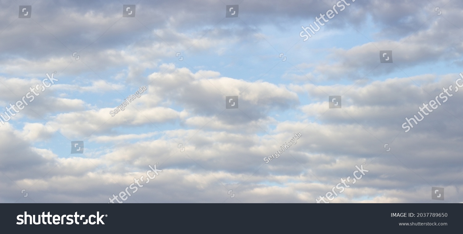 Big gray-white majestic clouds on soft blue sky #2037789650