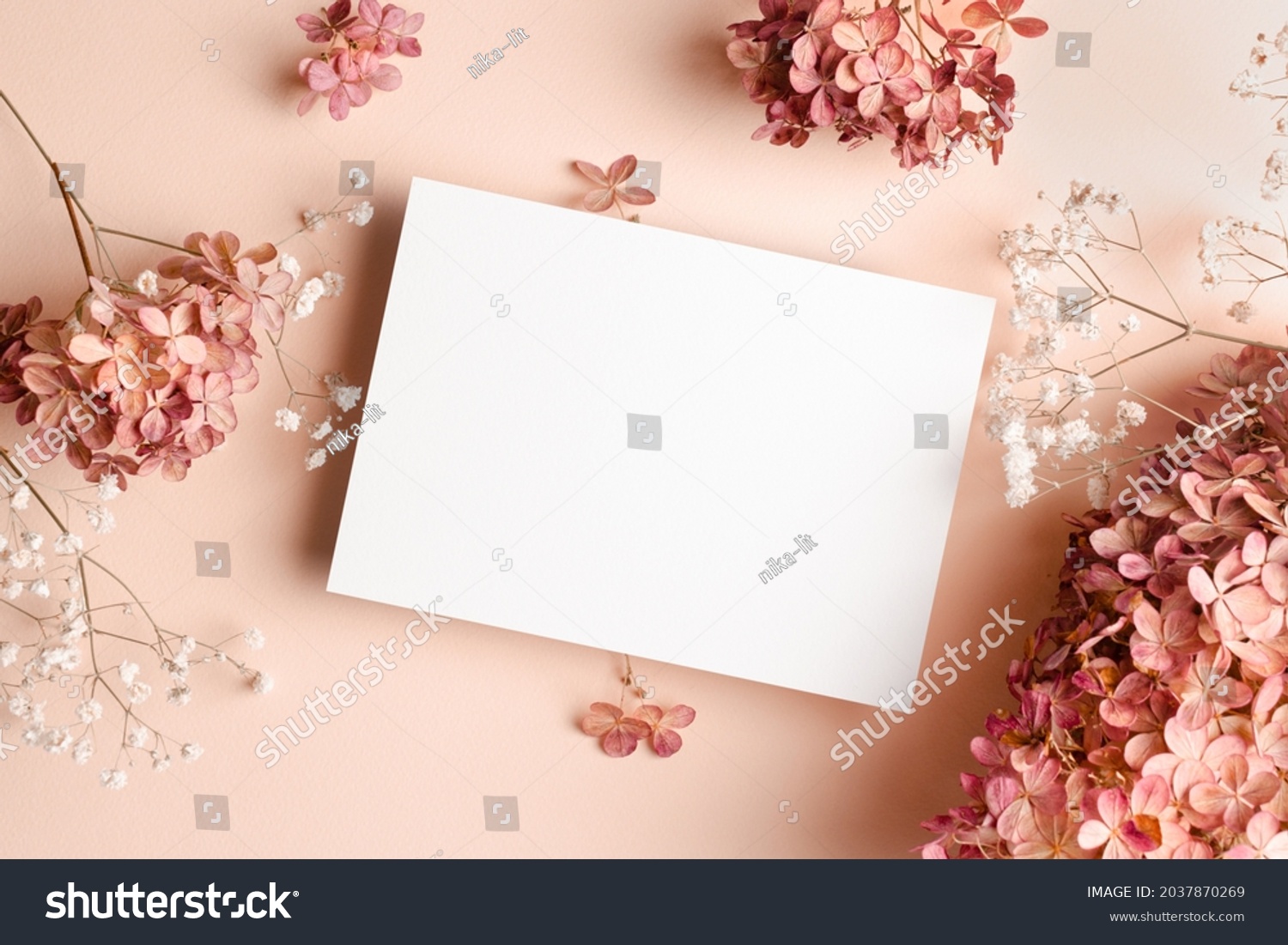 Invitation card mockup with hydrangea and gypsophila flowers decorations. Blank greeting card mockup. #2037870269
