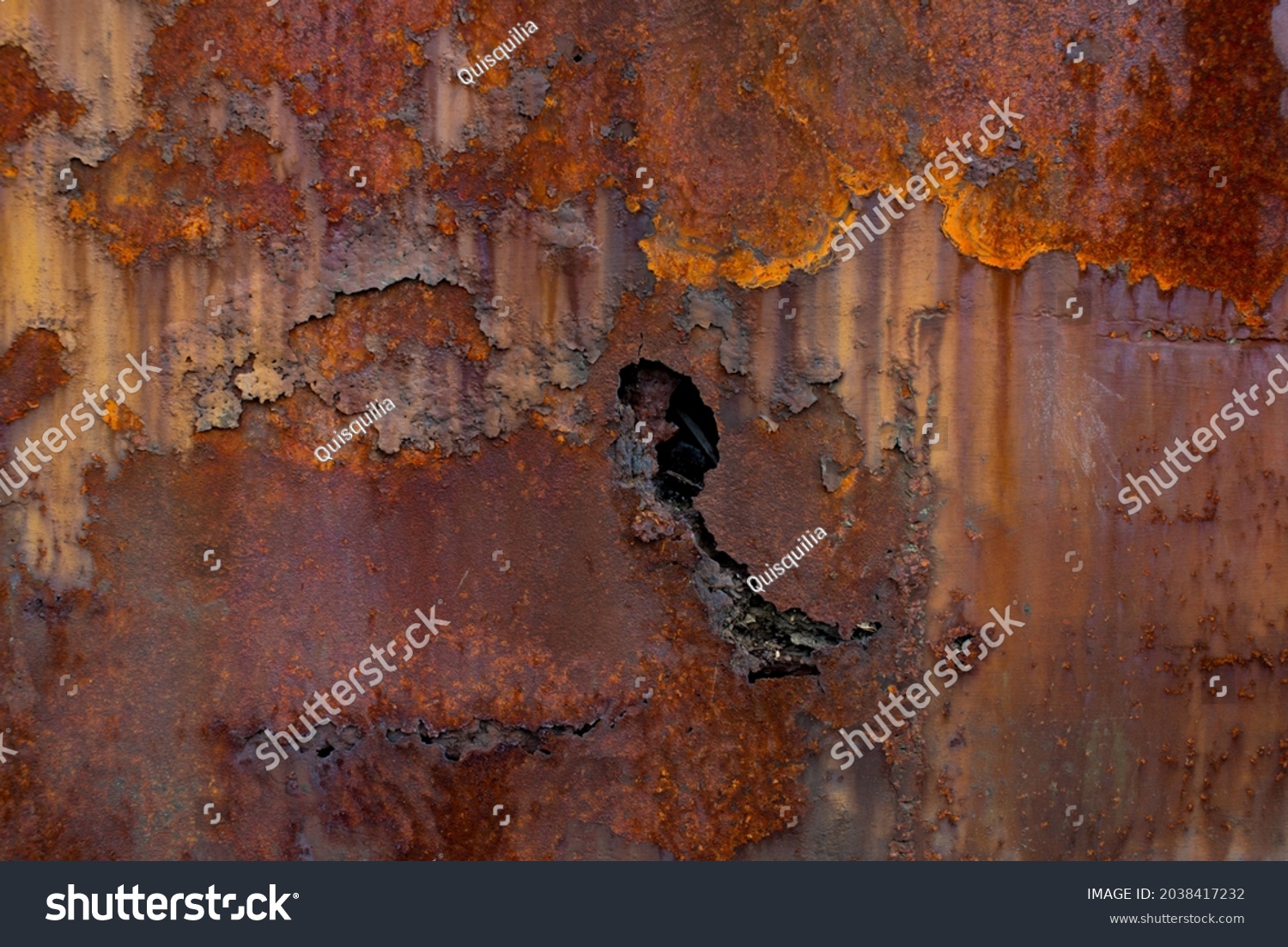 Rust of metals.Corrosive Rust on old iron with a hole. Rusted orange painted metal wall. Rusty metal background with streaks of rust. Old shabby paint.metal rust texture background #2038417232