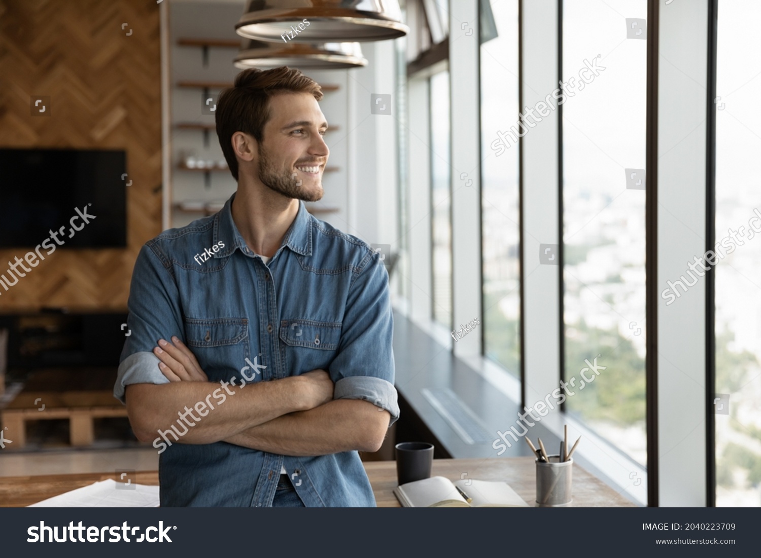 Smiling male employee stand at workplace look in window distance thinking pondering of future caress opportunities perspectives. Happy man imagine visualize success. Business vision concept. #2040223709