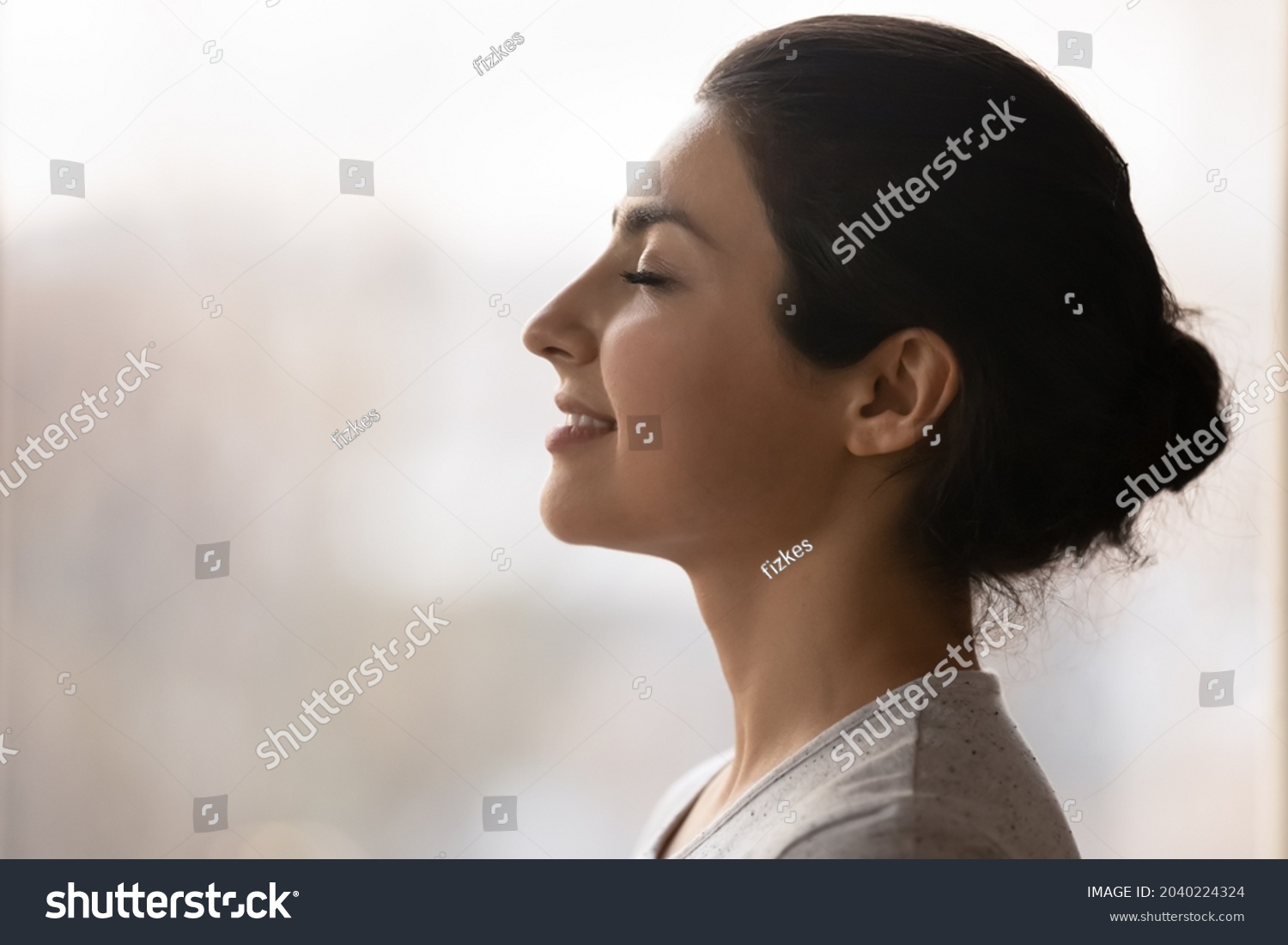 Meditation. Side profile shot of happy serene young indian female face. Calm millennial ethnic lady breath deep with closed eyes meditate feel zen good harmony peace of mind practice yoga meet new day #2040224324