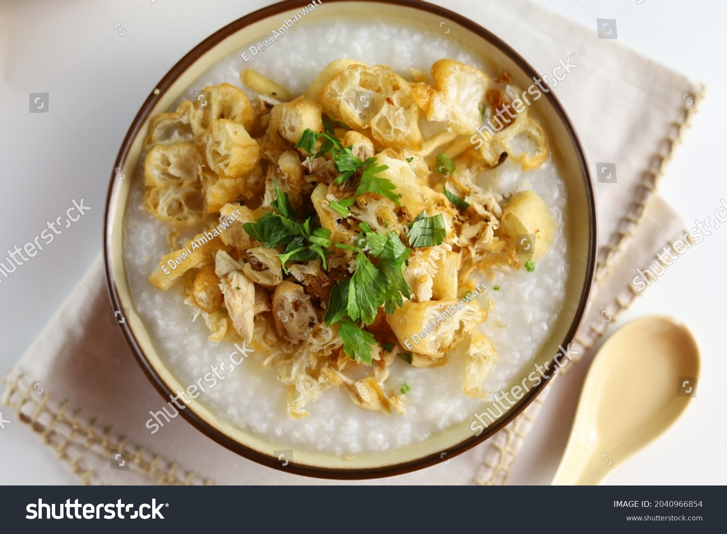 Bubur Ayam or Indonesian Rice Porridge with Shredded Chicken, cheese stick and cakwe. Top view #2040966854