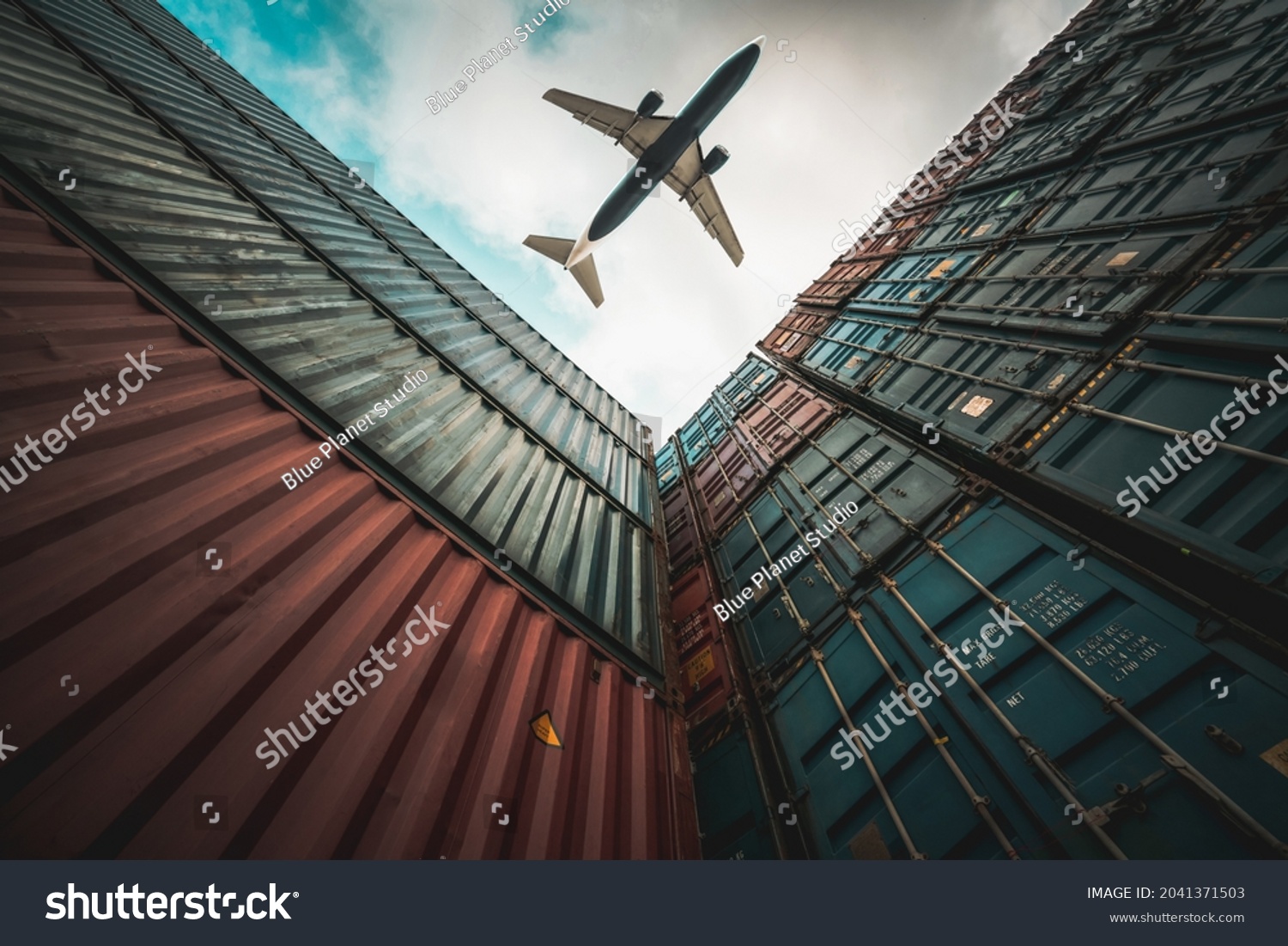 Freight airplane flying above overseas shipping container . Logistics supply chain management and international goods export concept . #2041371503