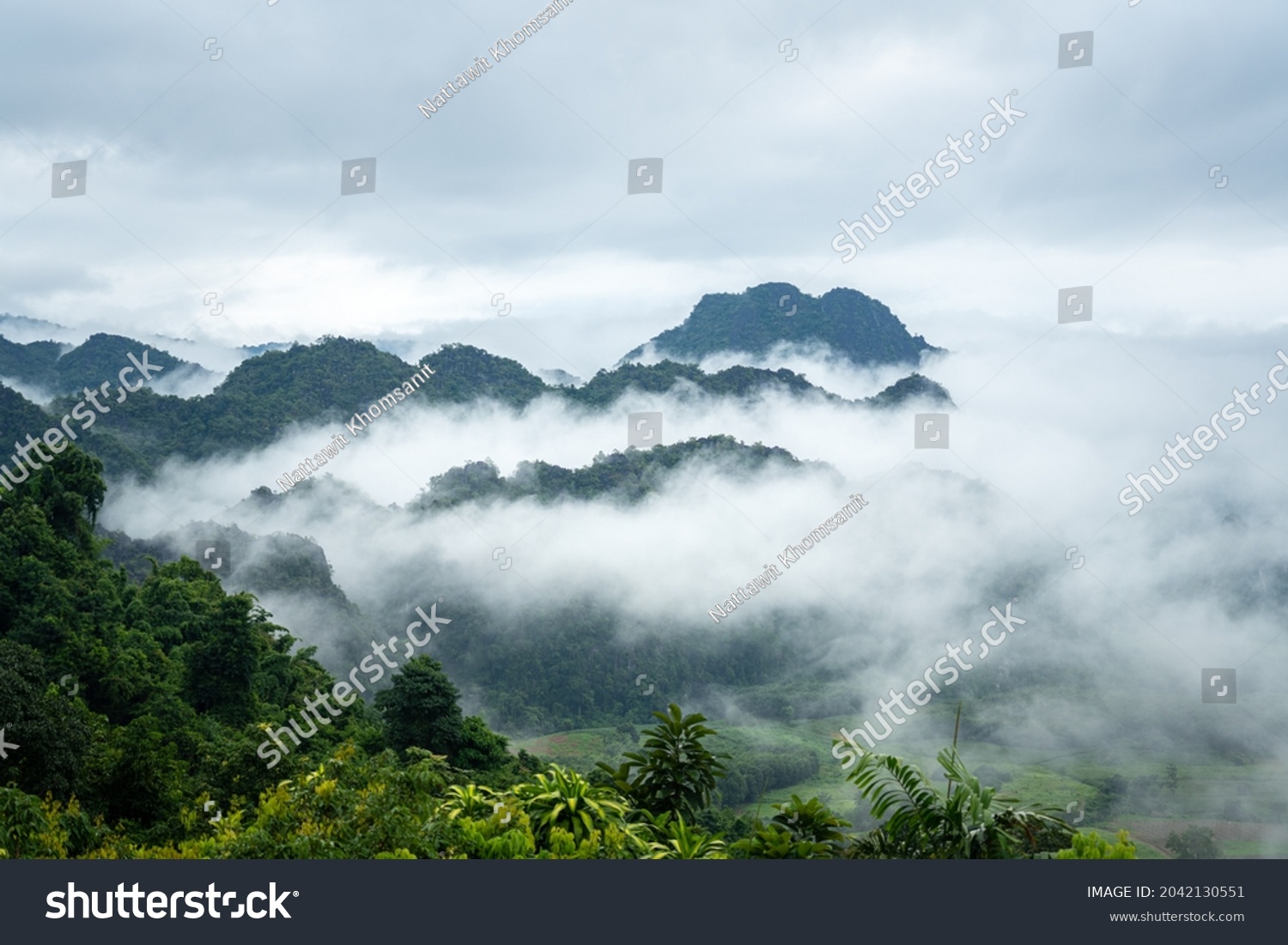 A beautiful view of mountain range with greenery forest and misty environment in the morning time. Relaxation with nature view, scenic photo seen. #2042130551