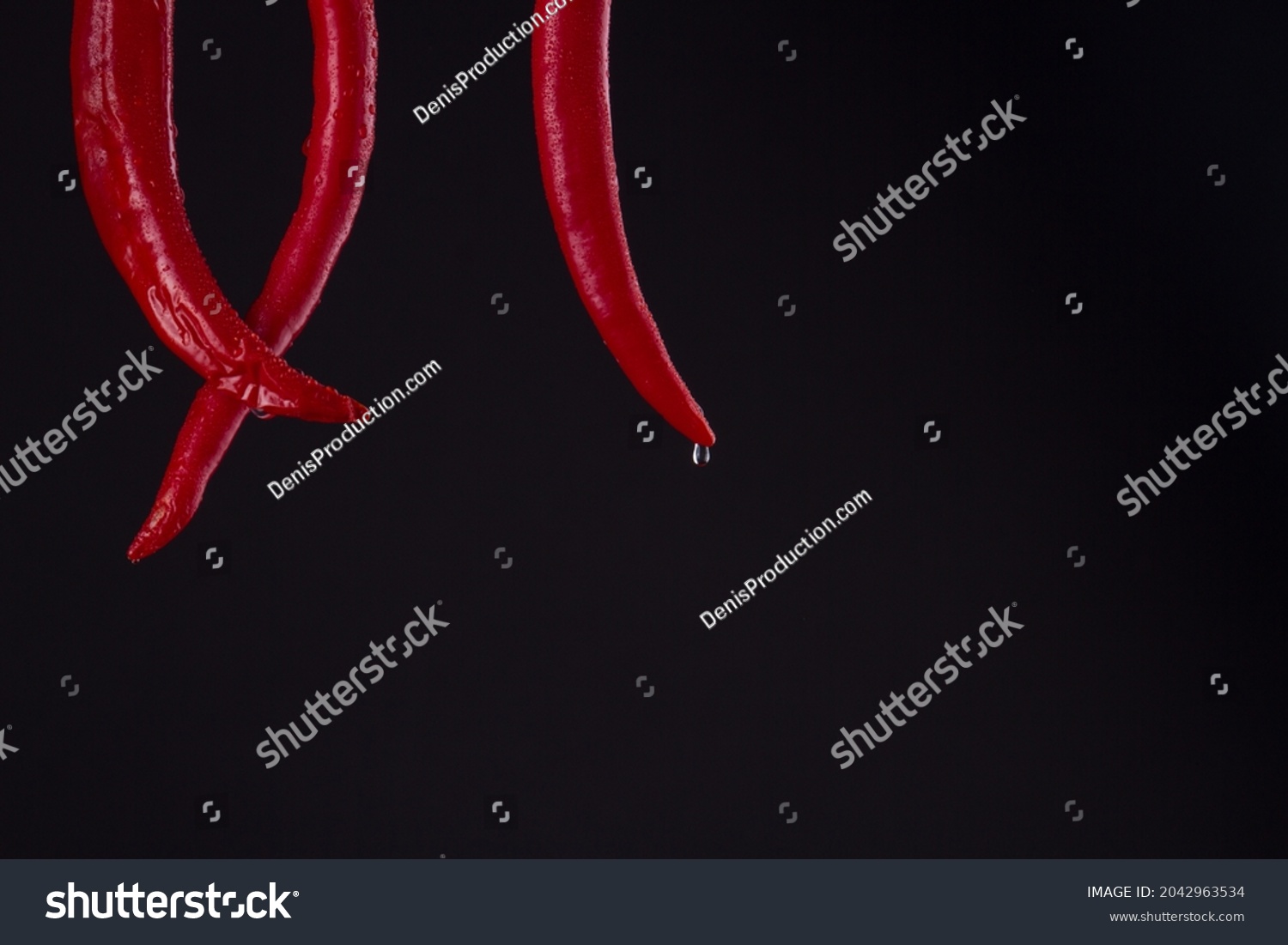 Red crossed chili tails with drops. #2042963534
