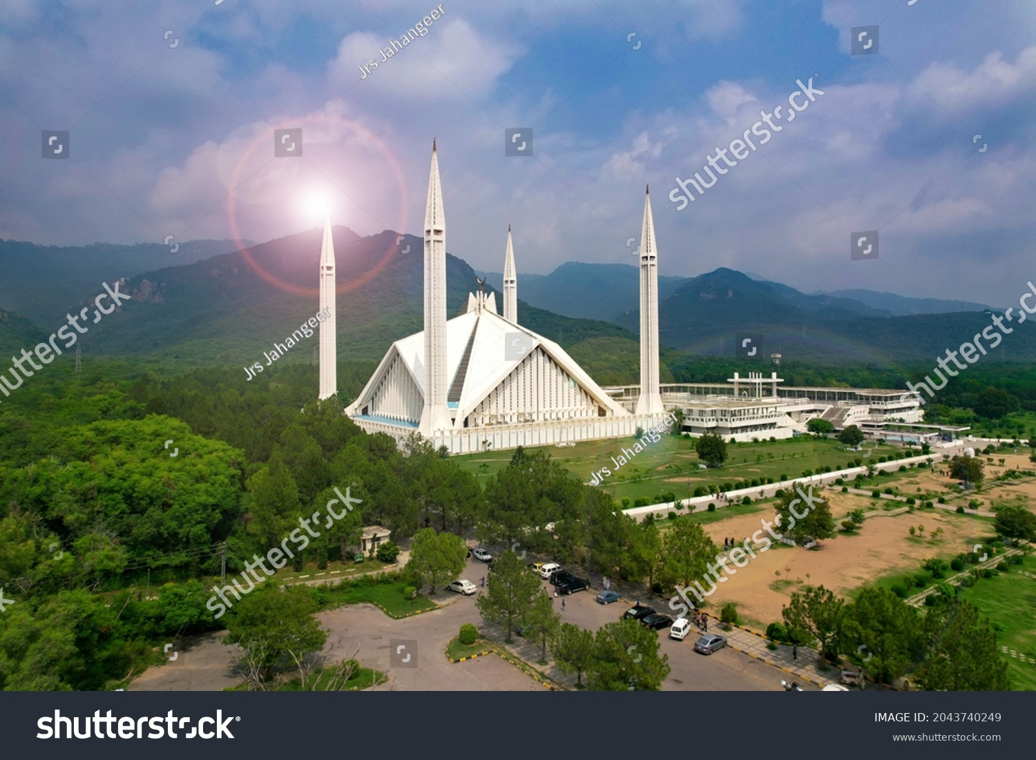 Aerial shot of Islamabad, the capital city of Pakistan showing the landmark Shah Faisal Mosque and the lush green mountains of Margala Hills #2043740249
