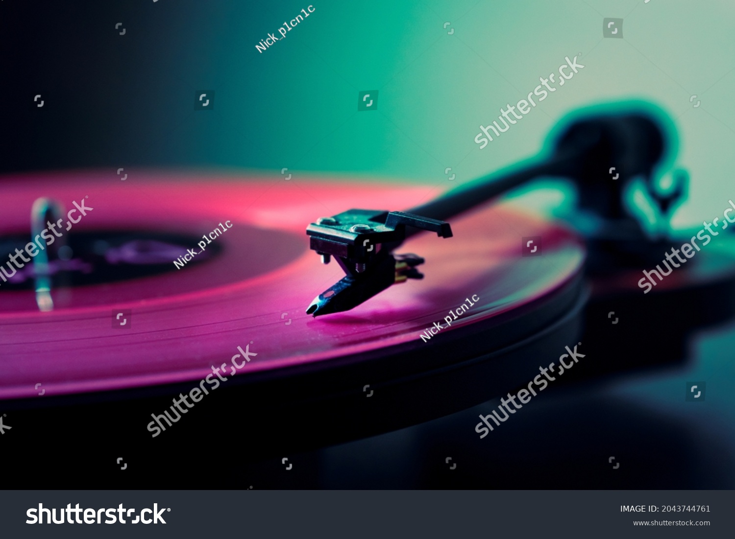 Vinyl DJ turntable in club lighting. close-up. pink tint #2043744761