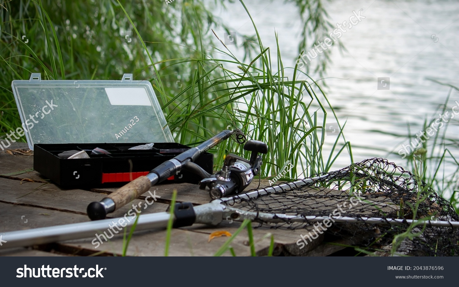 Fishing tackle on the river bank, bait rod, spinning rod, fish. Nature. Selective focus #2043876596