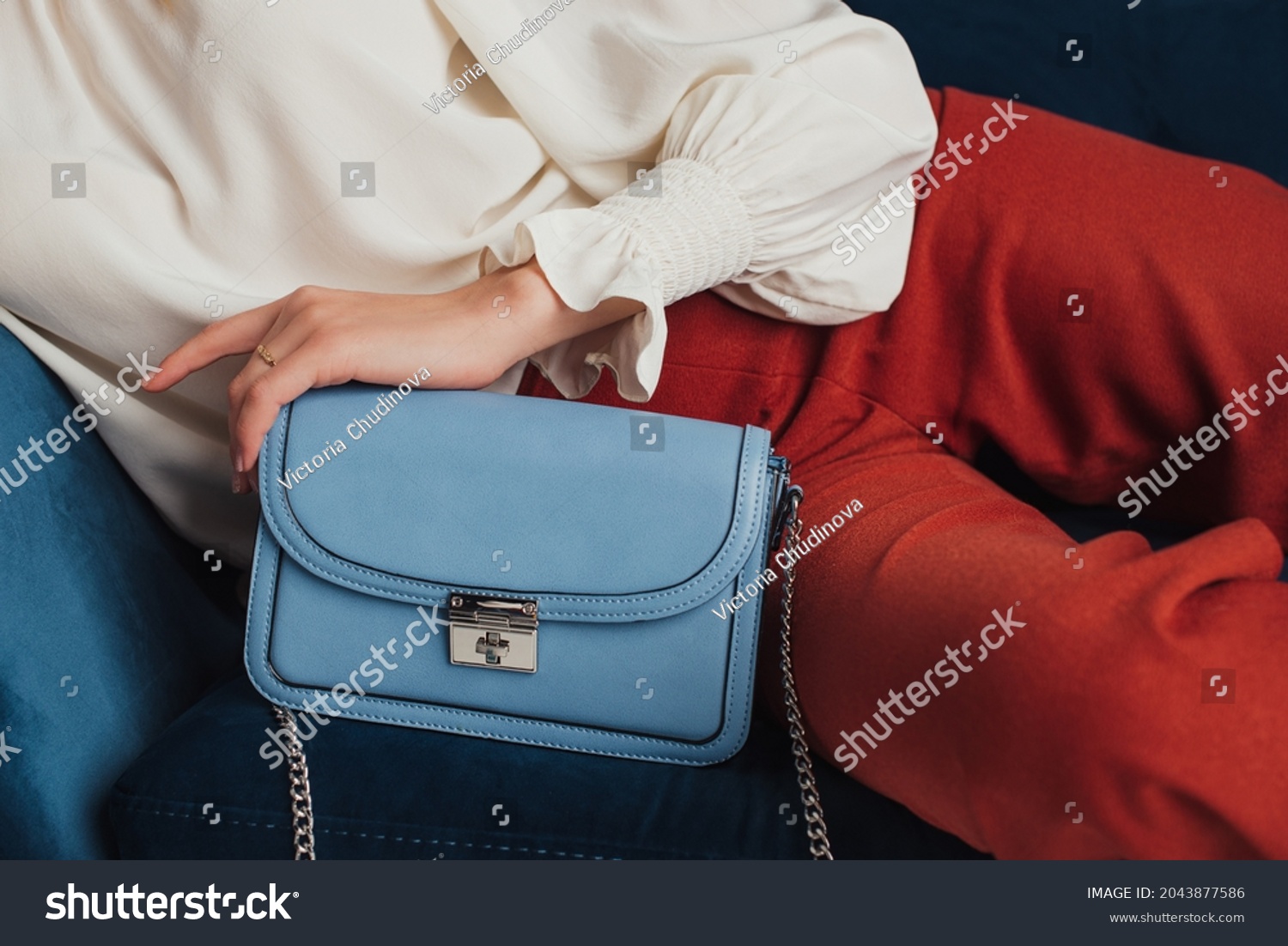 Blue faux leather small rectangle bag in trendy autumn woman outfit. Fashion details. Copy, empty space for text #2043877586