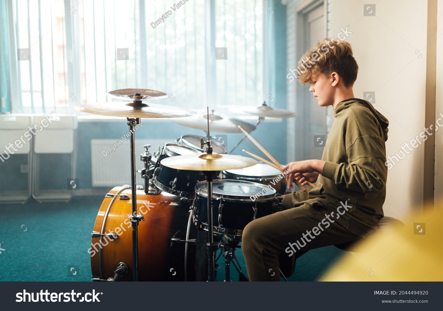 Boy musician behind a drum kit. #2044494920