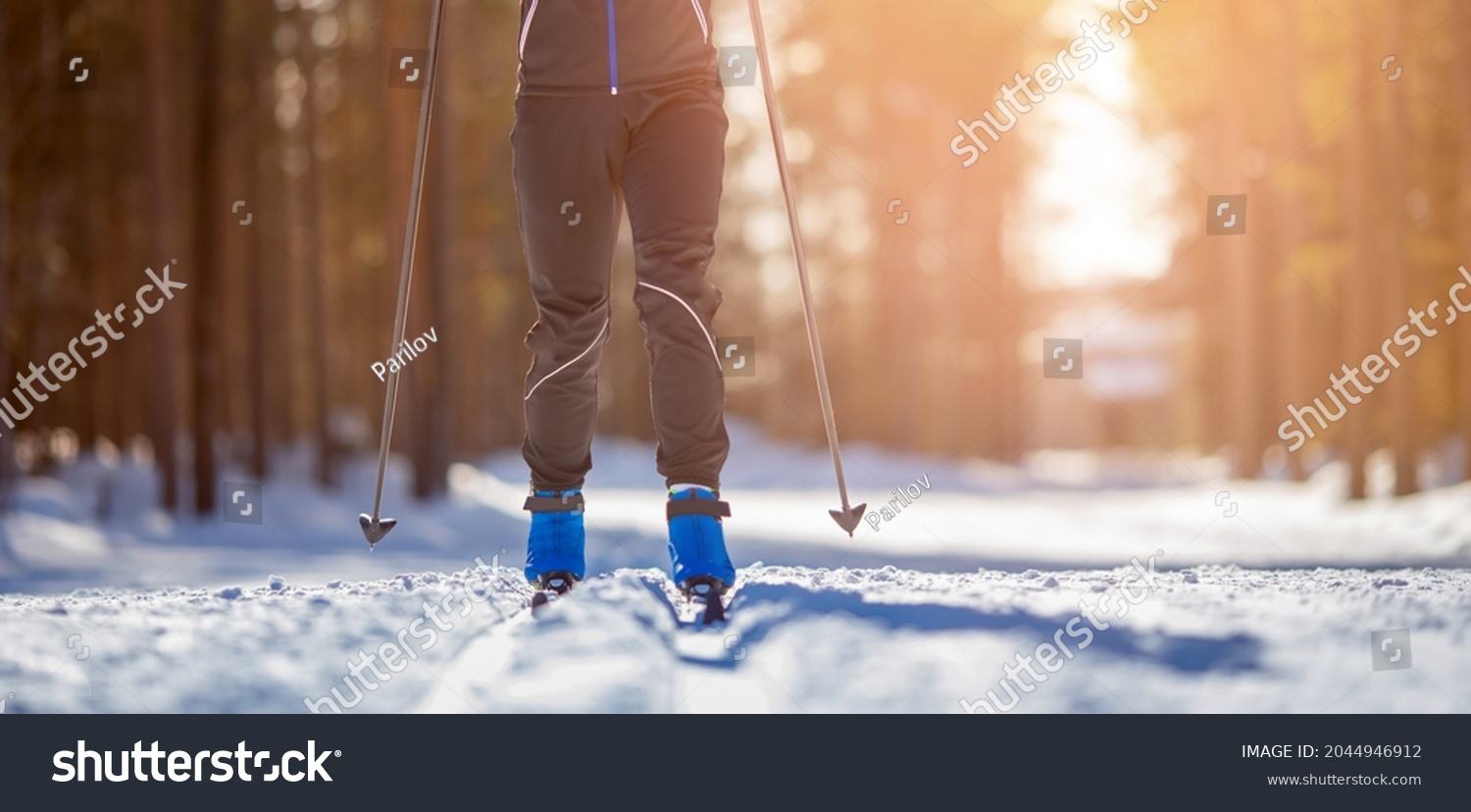 Cross country skiing Banner, winter sport on snowy track, sunset background. #2044946912
