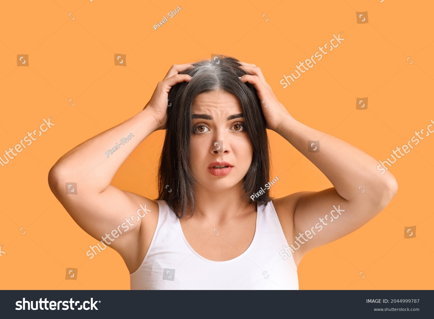 Stressed woman with graying hair on color background #2044999787