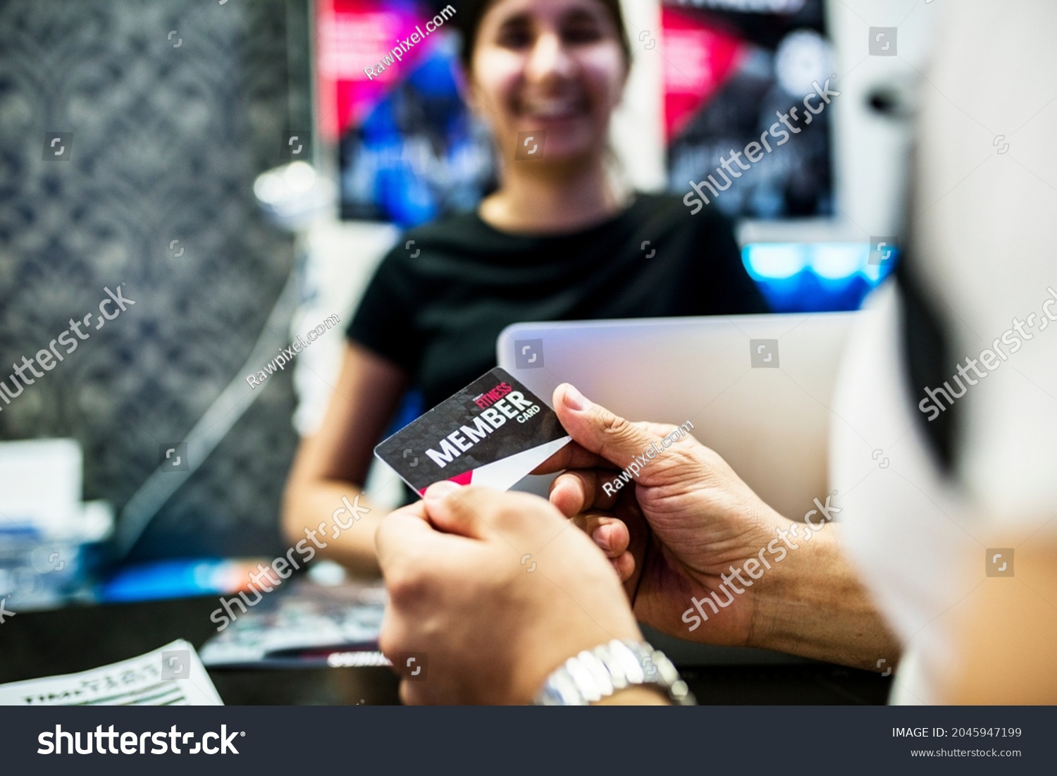 Woman holding a fitness membership card #2045947199
