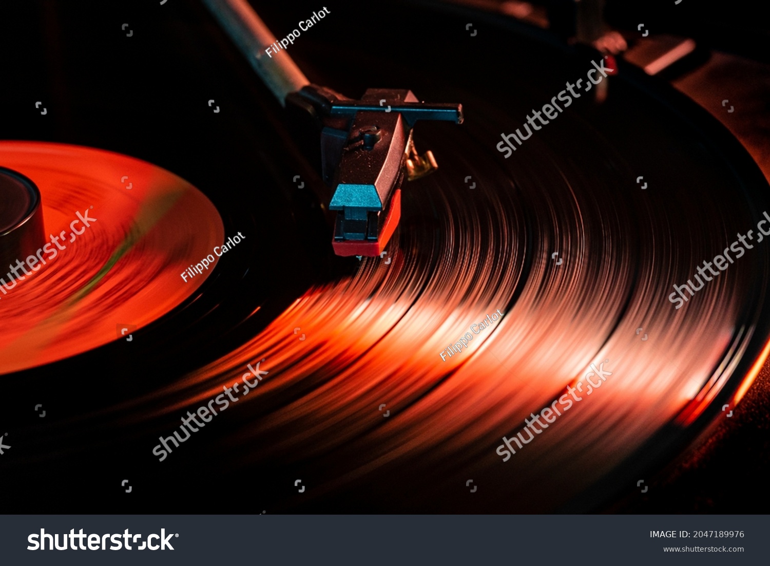Needle detail on vinyl record on turntable, low light image with reflection #2047189976