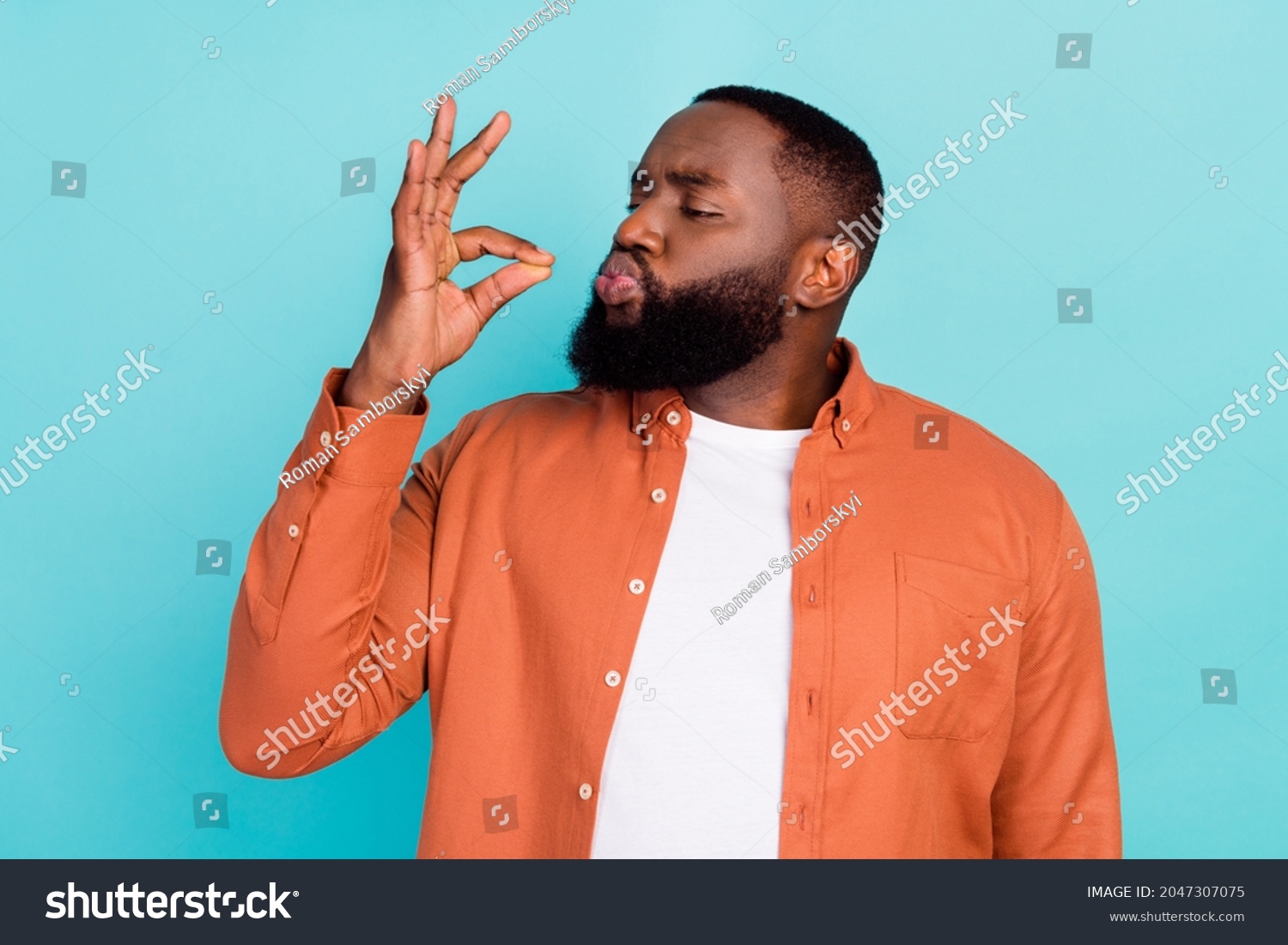 Photo of young african man show fingers tasty delicious perfect gourmet sign isolated over turquoise color background #2047307075