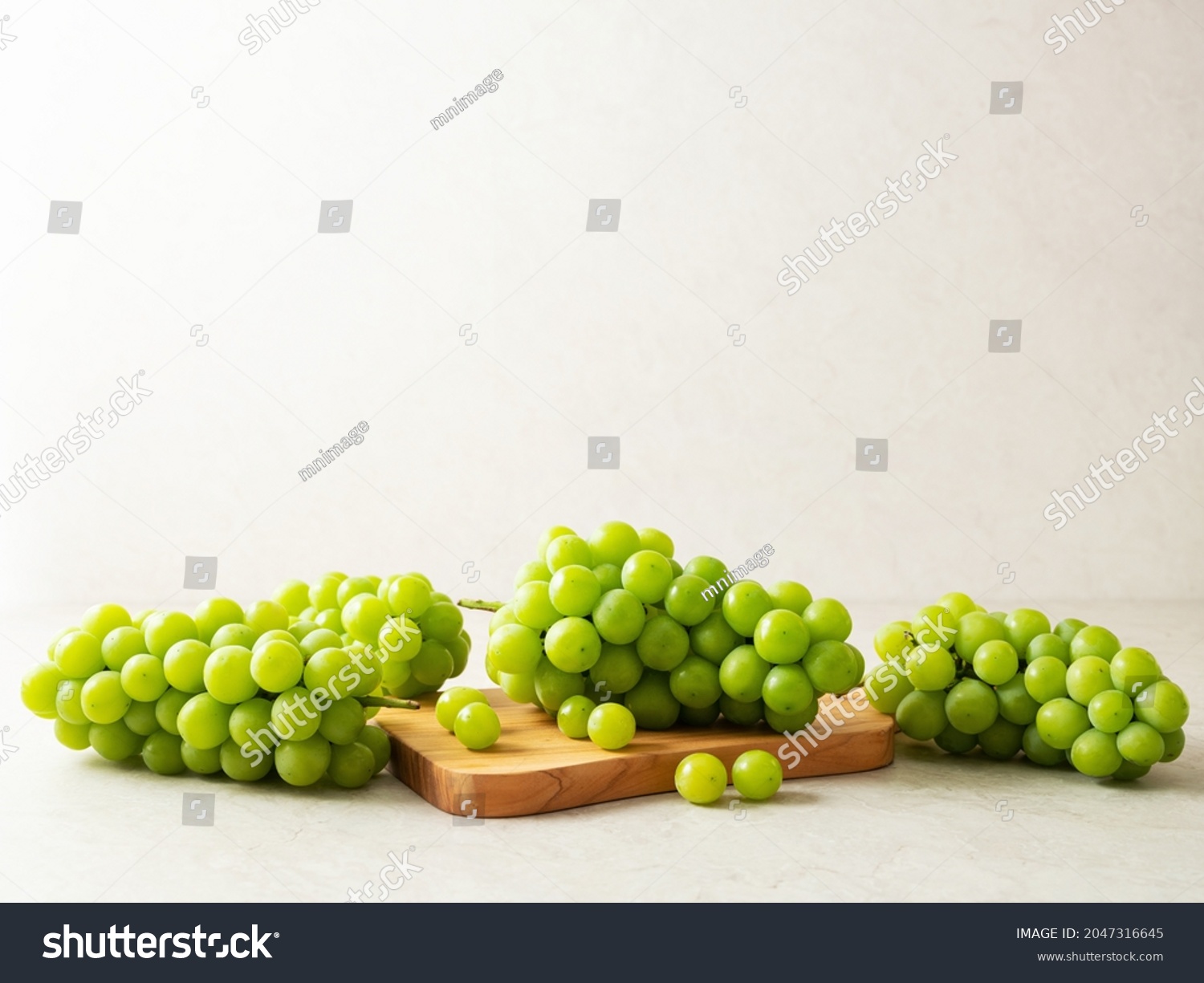 Shine Muscat, Green grapes on a cutting board  #2047316645