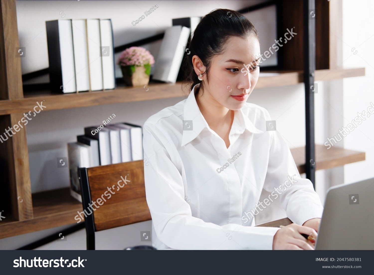 Asian manger businesswoman or secretary operator is researching and working with laptop at office. Collegian is studying knowledge in library at the university. Business and education with technology. #2047580381