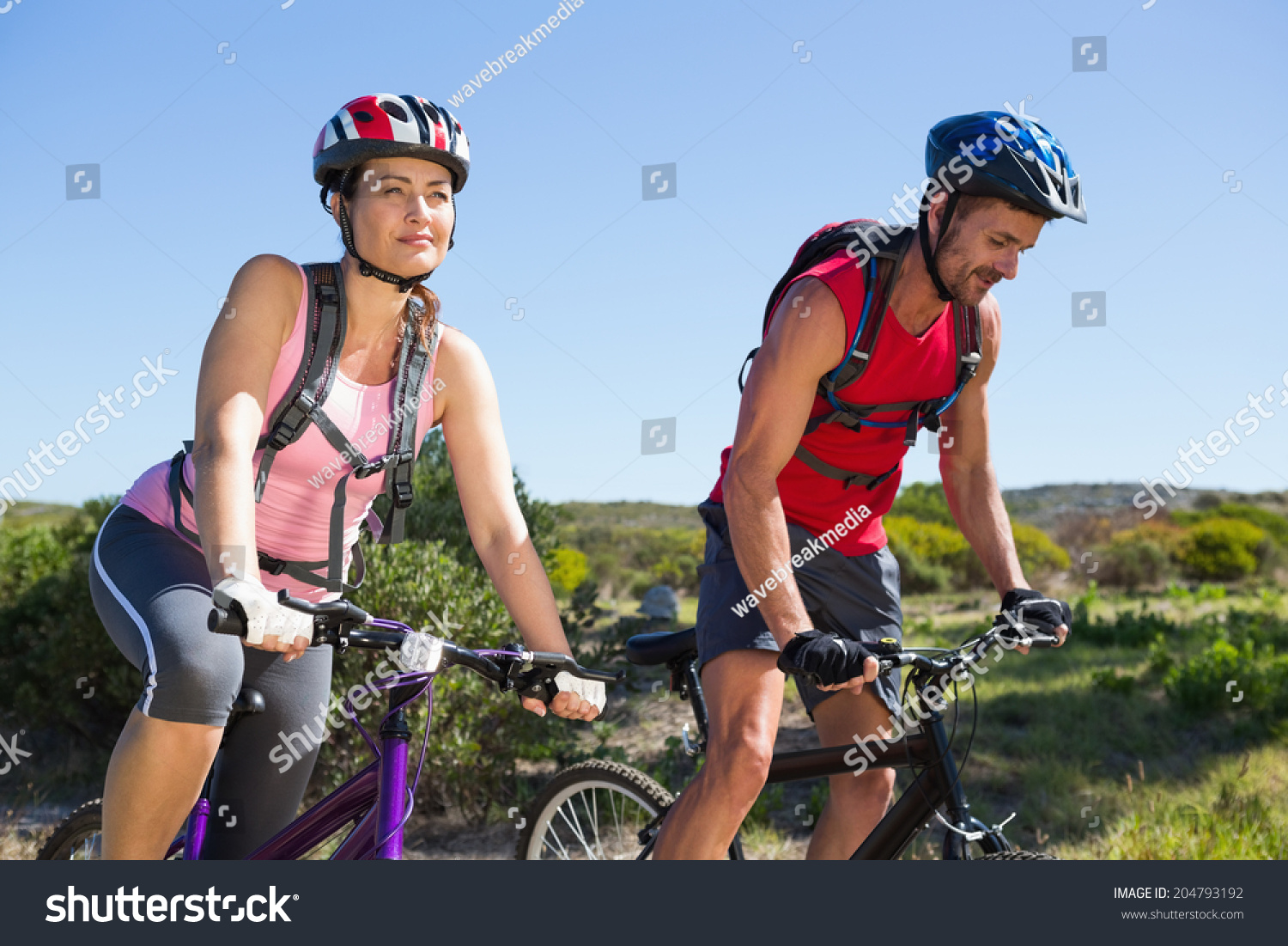 Active couple cycling in the countryside on a sunny day #204793192