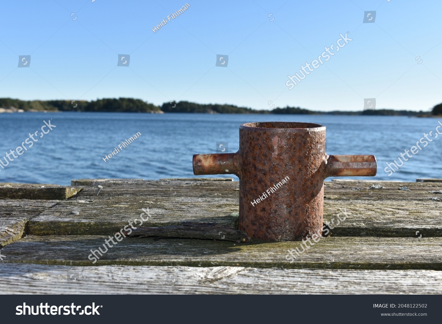 old rusty boat fastening tamp on wharf #2048122502