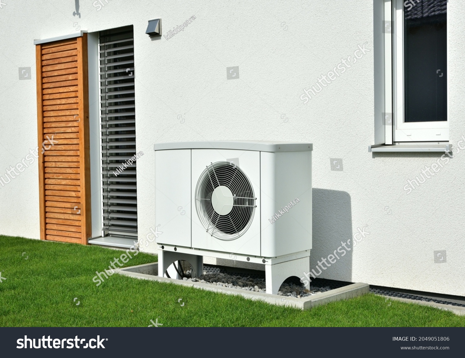 Air-Air Heat Pump for Heating and hot Water in Front of an new built Residential Building #2049051806
