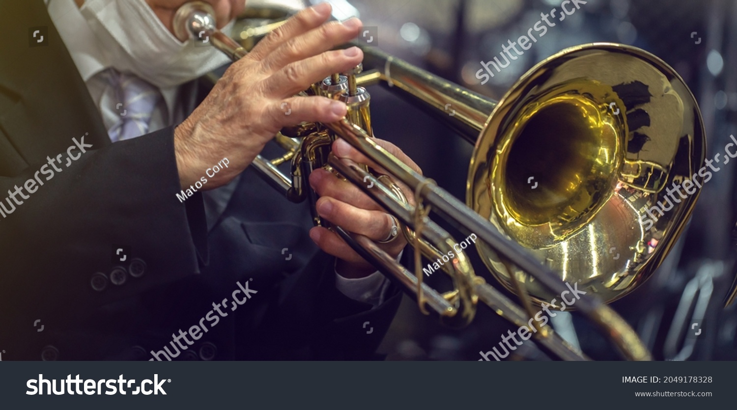 man playing the trombone. golden metal instrument detail. to use in banners or presentations #2049178328