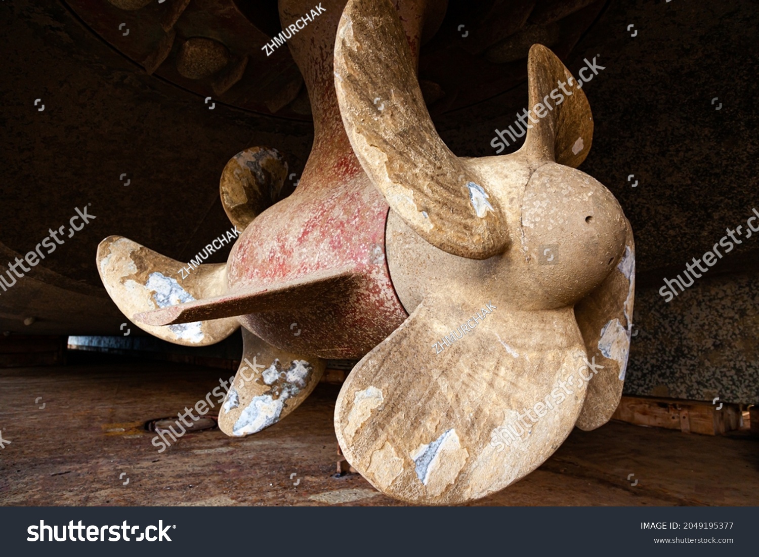 The bottom of a ship supported in dry dock with azimuth propulsion and twin propellers aft. #2049195377
