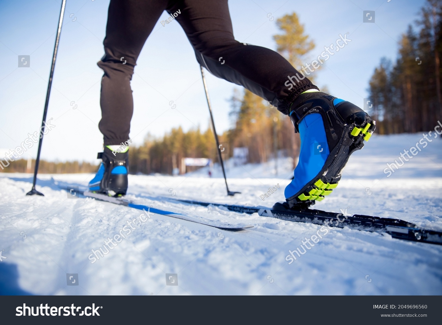Winter sports competitions, boots and sticks cross of country skis glide on fresh snow. #2049696560