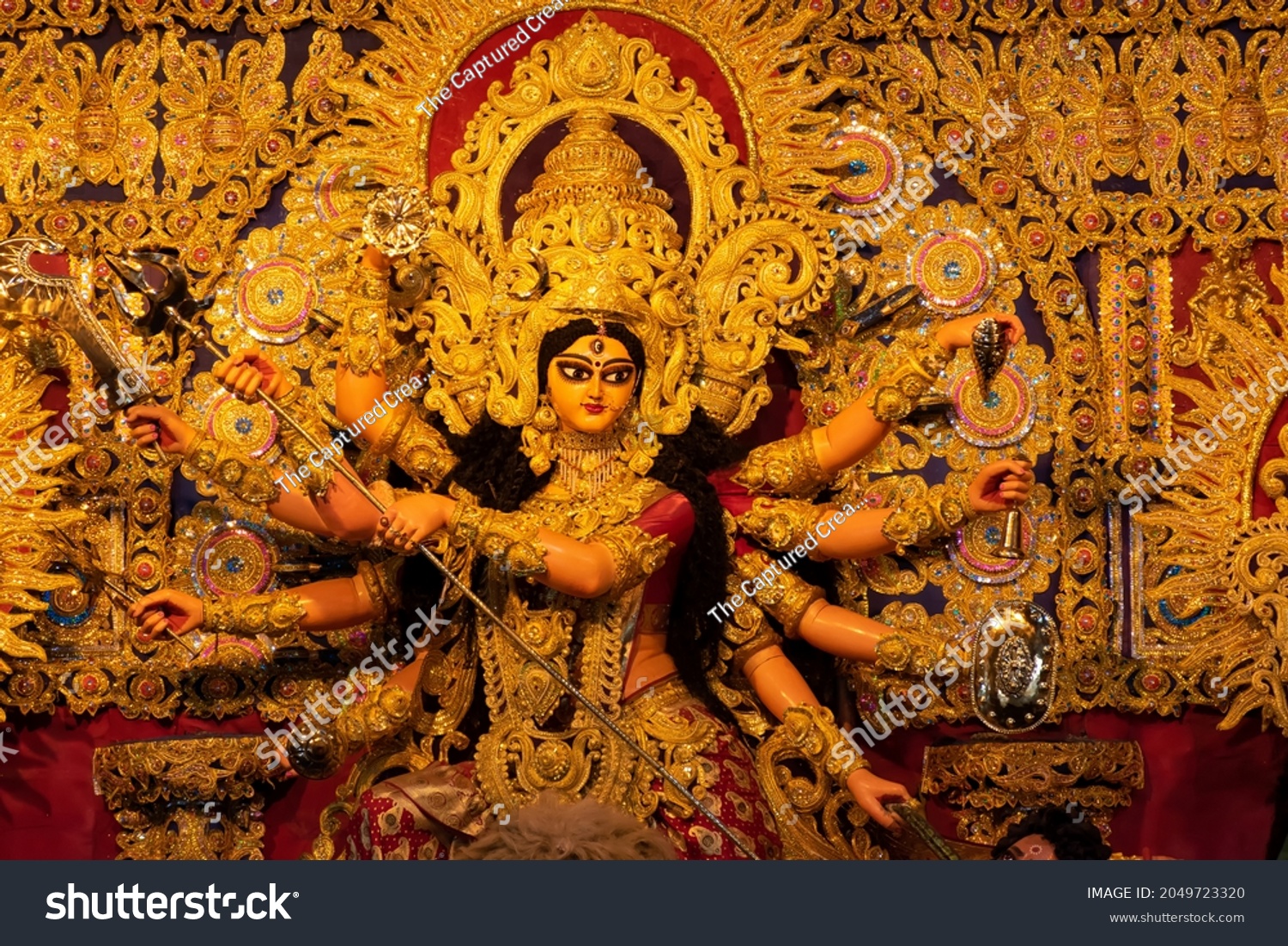 Idol of Goddess Devi Durga at a decorated puja pandal in Kolkata, West Bengal, India. Durga Puja is a famous and major religious festival of Hinduism that is celebrated throughout the world. #2049723320
