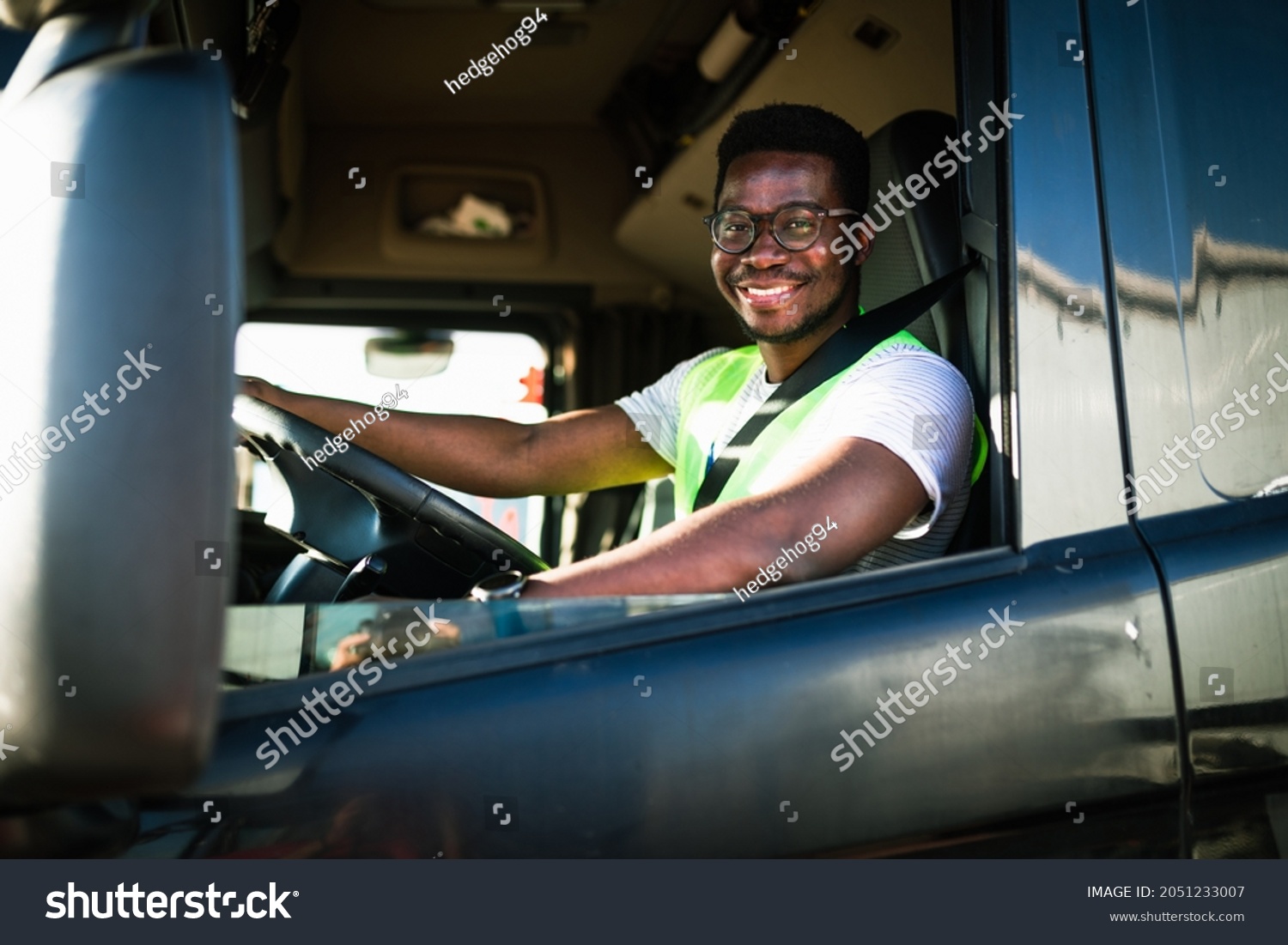 Young handsome African American man working in towing service and driving his truck. #2051233007