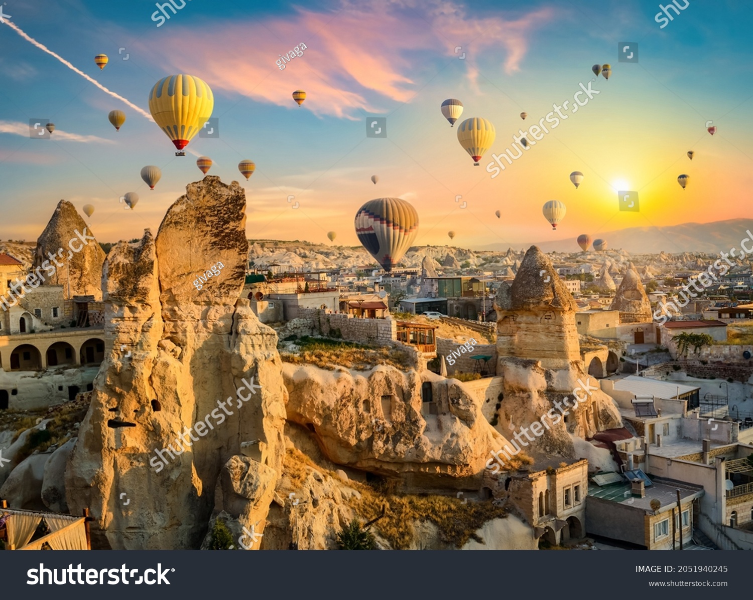 Hot air balloons at sunset in Goreme village, Cappadocia, Turkey #2051940245