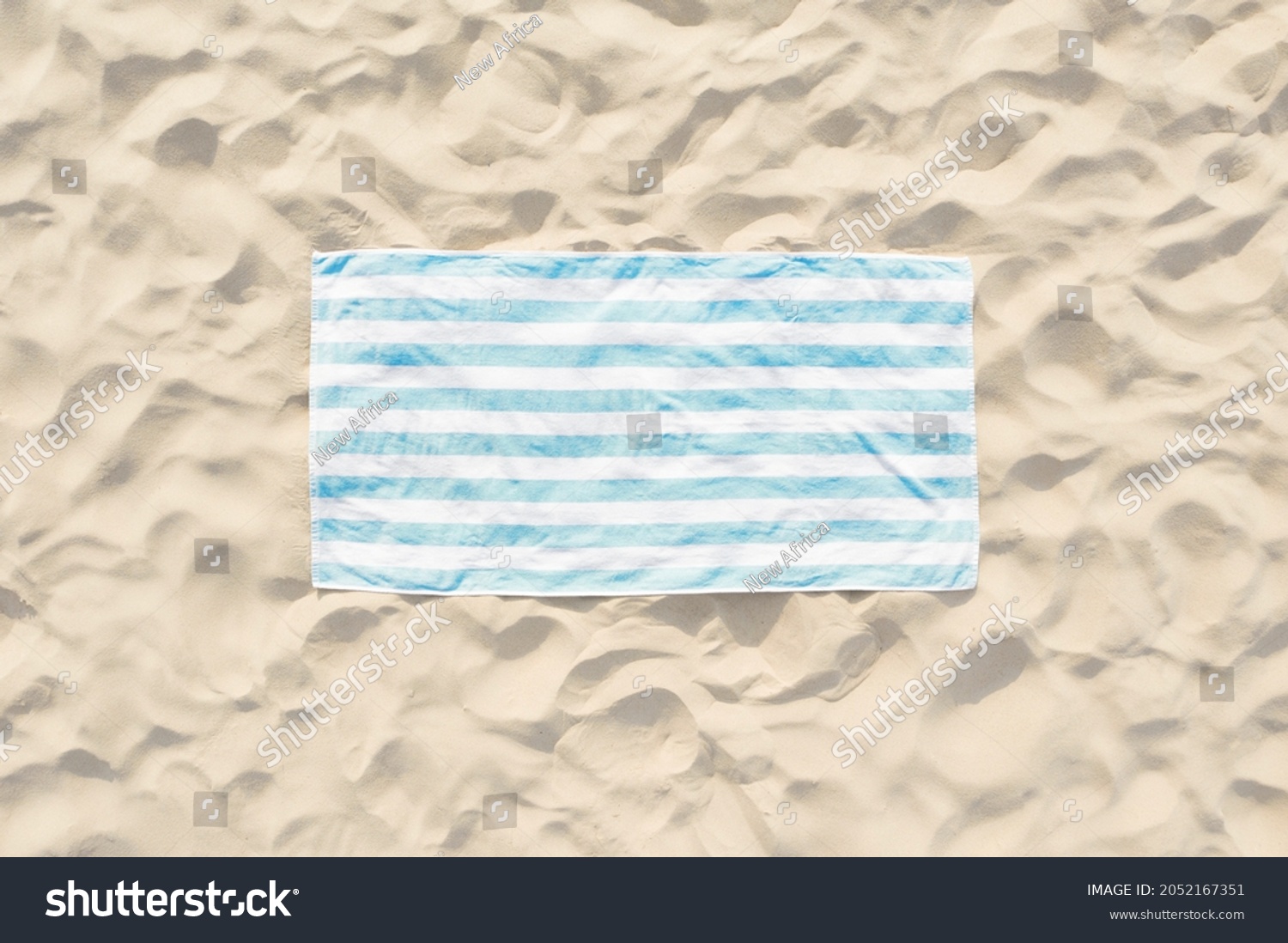 Striped beach towel on sand, aerial view #2052167351
