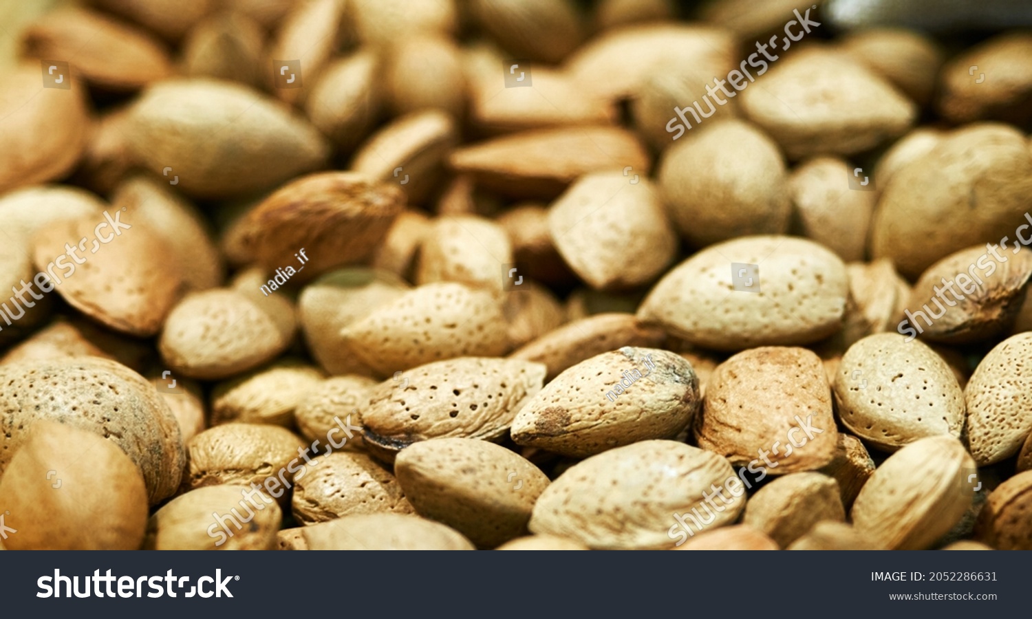 Tasty fresh almond nuts, background, texture. Selective focus. High quality photo #2052286631