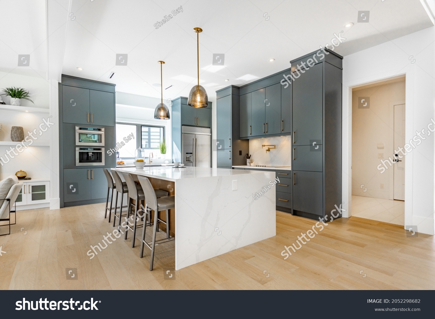 contemporary kitchen spice kitchen with grey cabinets white marble counter top sinks range appliances eating counter and pendant lights #2052298682
