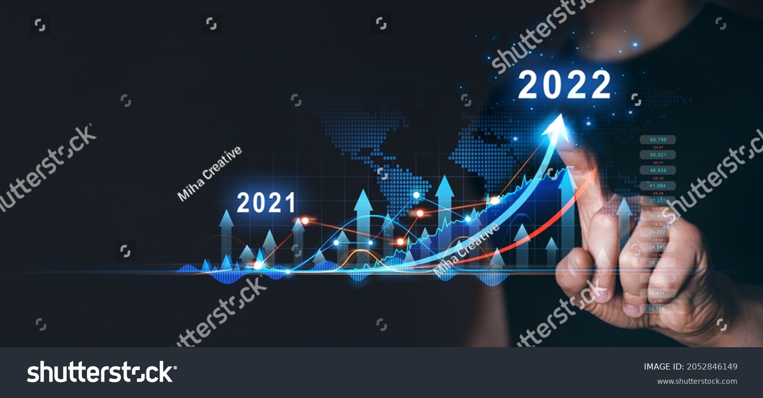 Businessman draws  increase arrow graph corporate future growth year 2021 to 2022.   Planning,opportunity, challenge and business strategy. New Goals, Plans and Visions for Next Year 2022. #2052846149