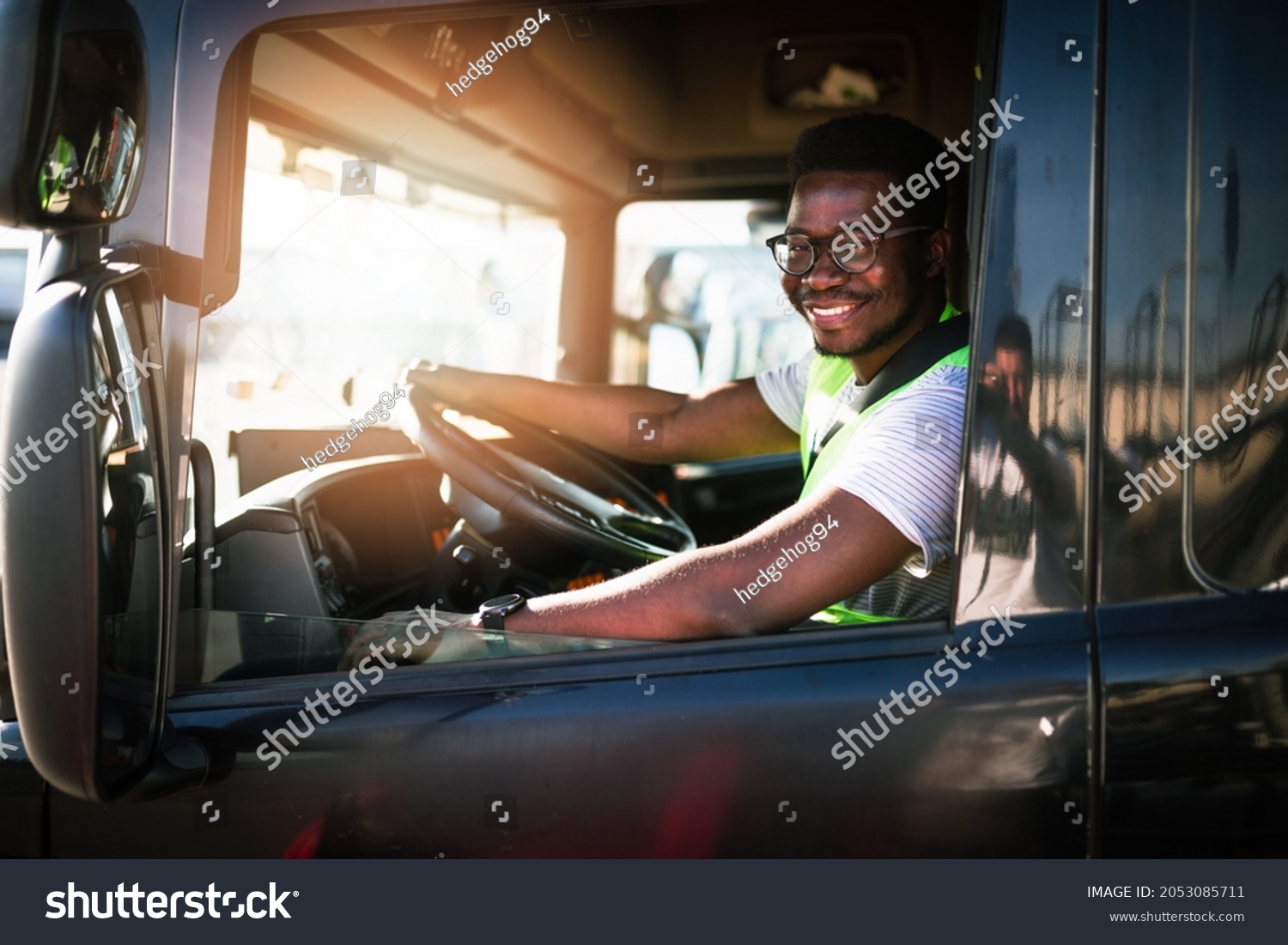 Young handsome African American man working in towing service and driving his truck. #2053085711