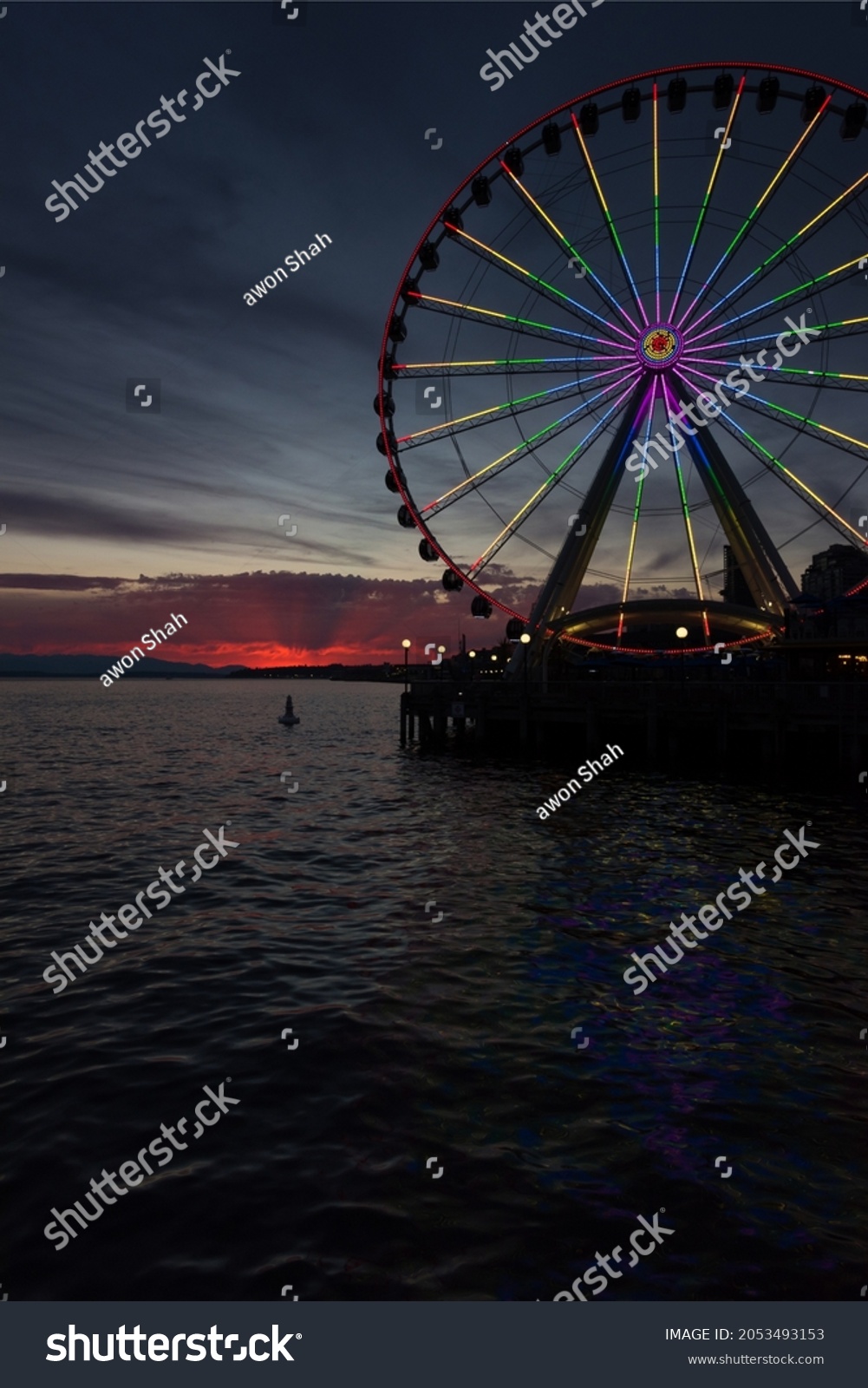 Elliott Bay sunset with Rainbow lights on the ferris wheel. #2053493153