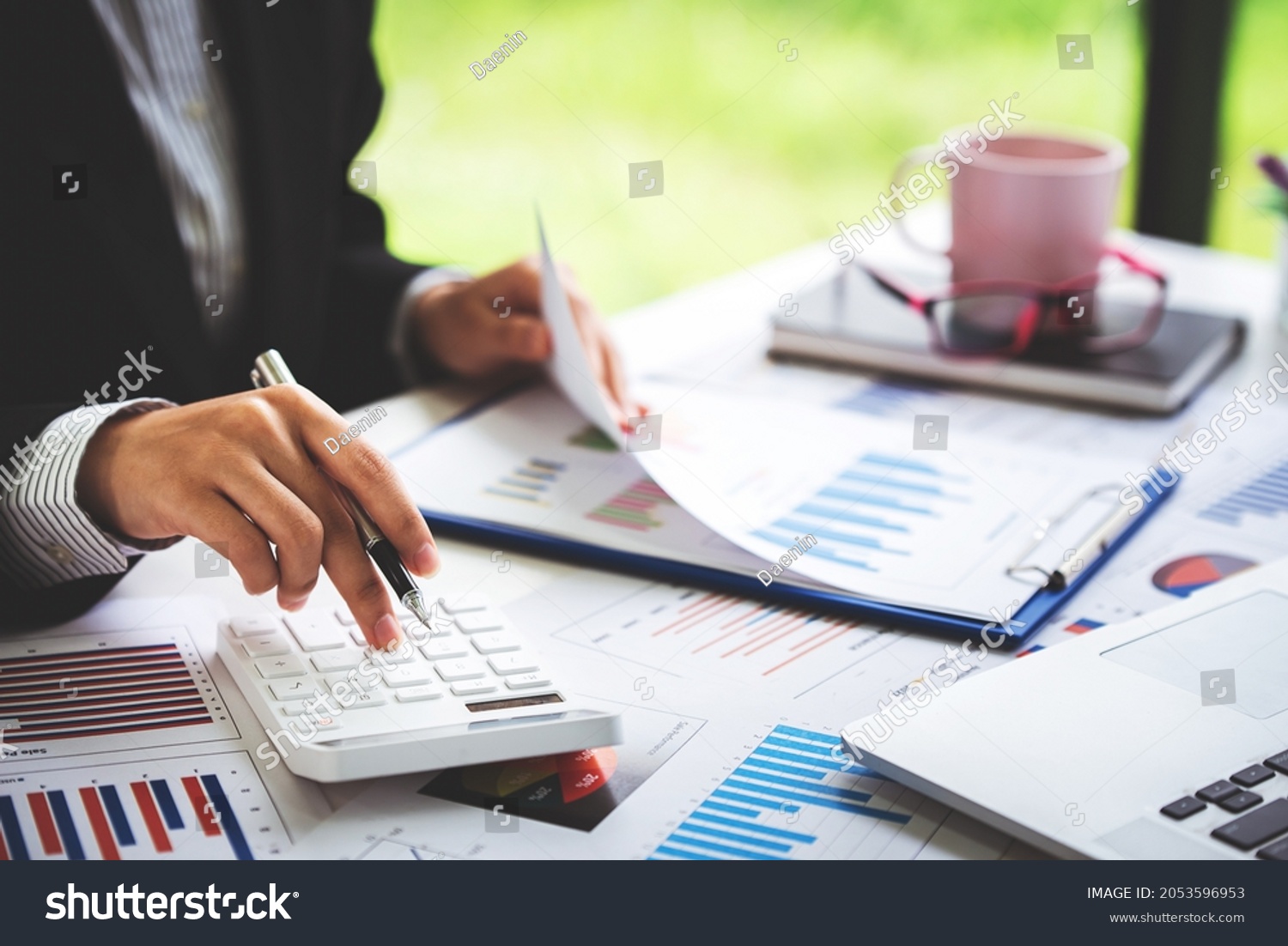 Close-up shot of woman pressing a calculator to review and summarize the cost of mortgage home loans for refinancing plans, lifestyle concept. #2053596953