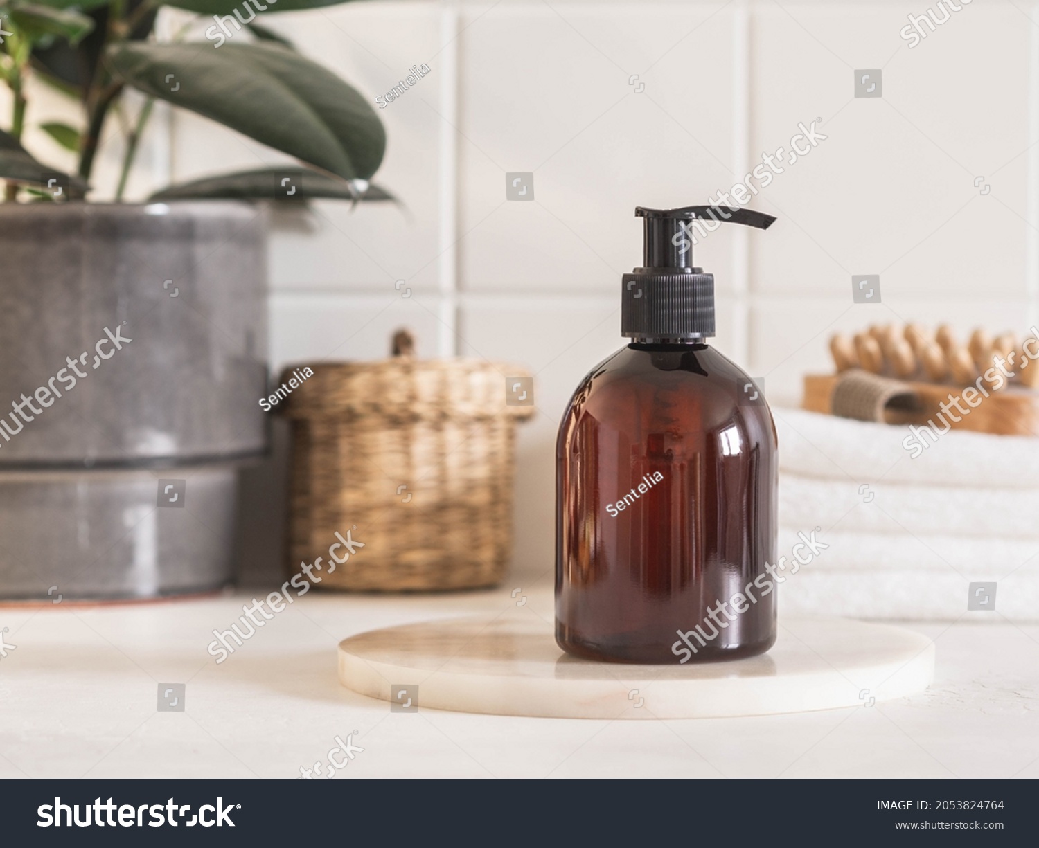 Brown bottle mockup for bathing products in bathroom, spa shampoo, shower gel, liquid soap on marble podium and various accessories front view. #2053824764