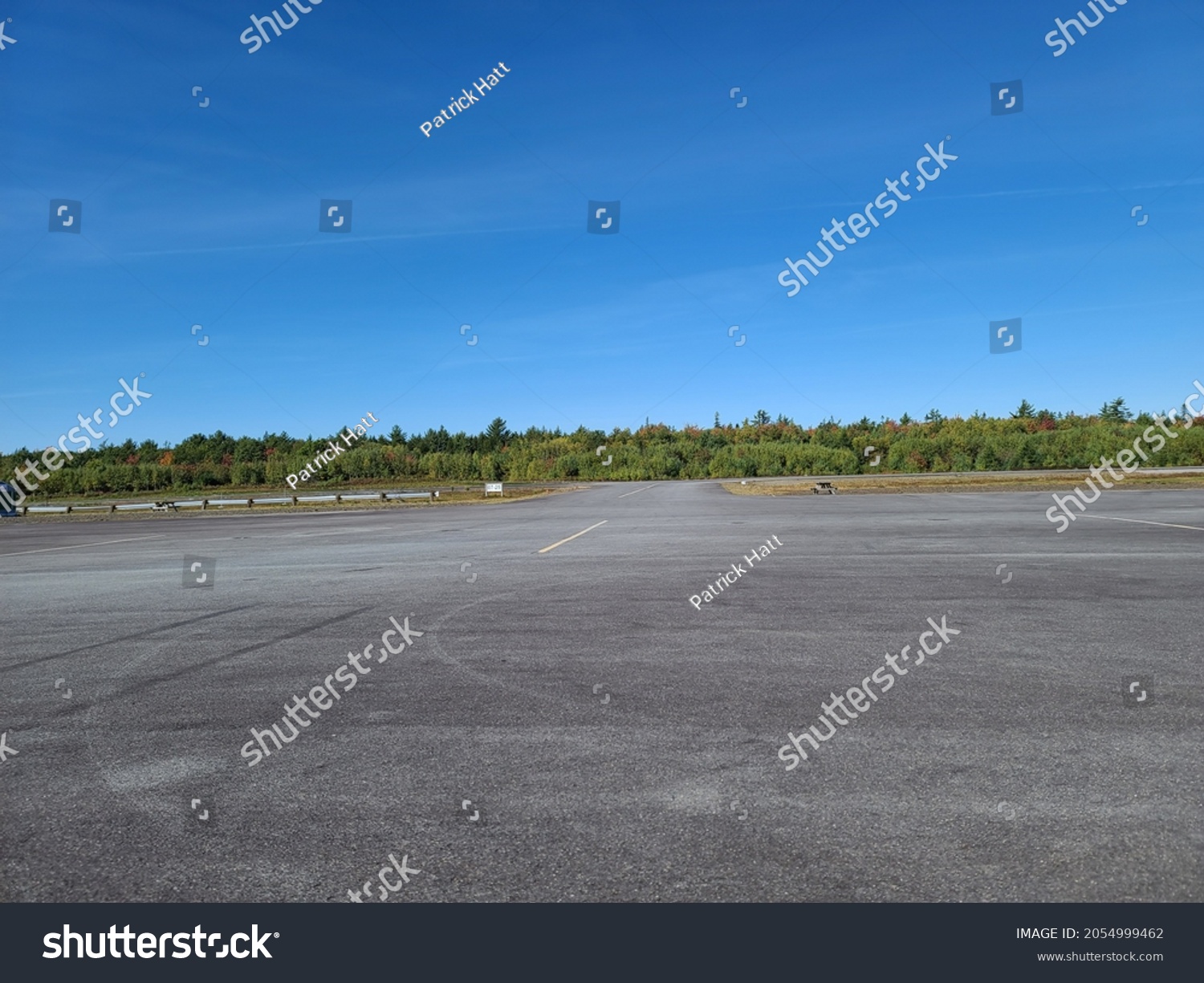 The large cement parking area at an airport. #2054999462