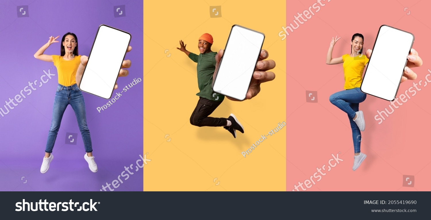 Glad excited young asian, european women and black guy jumping from joy and show phone with empty screen, isolated on colored background, collage. Great advice, offer and digital ad, new app, panorama #2055419690