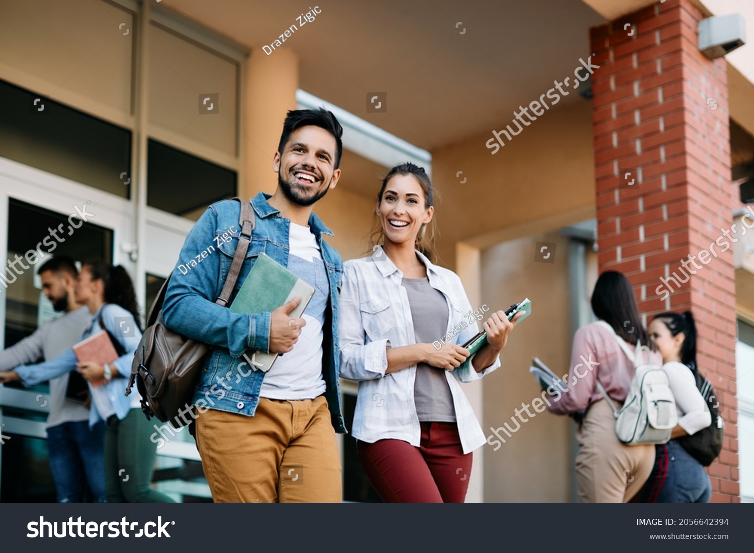 Happy university student and his female friend walking after the lecture at campus. #2056642394