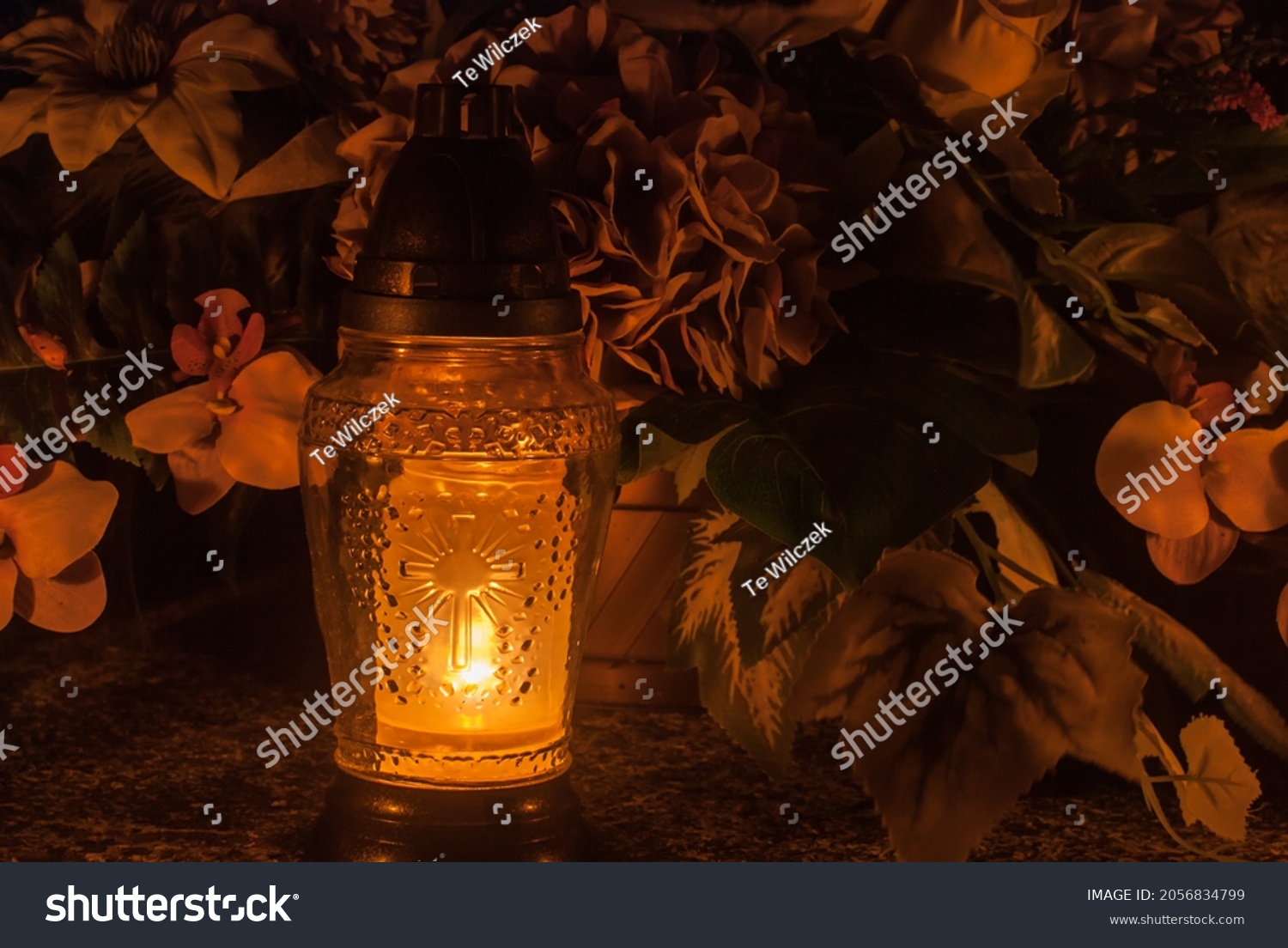Orange grave lantern shining with light. Cemetery at night. Catholic Halloween tradition. All souls' day in Poland, Eastern Europe. Zaduszki. #2056834799