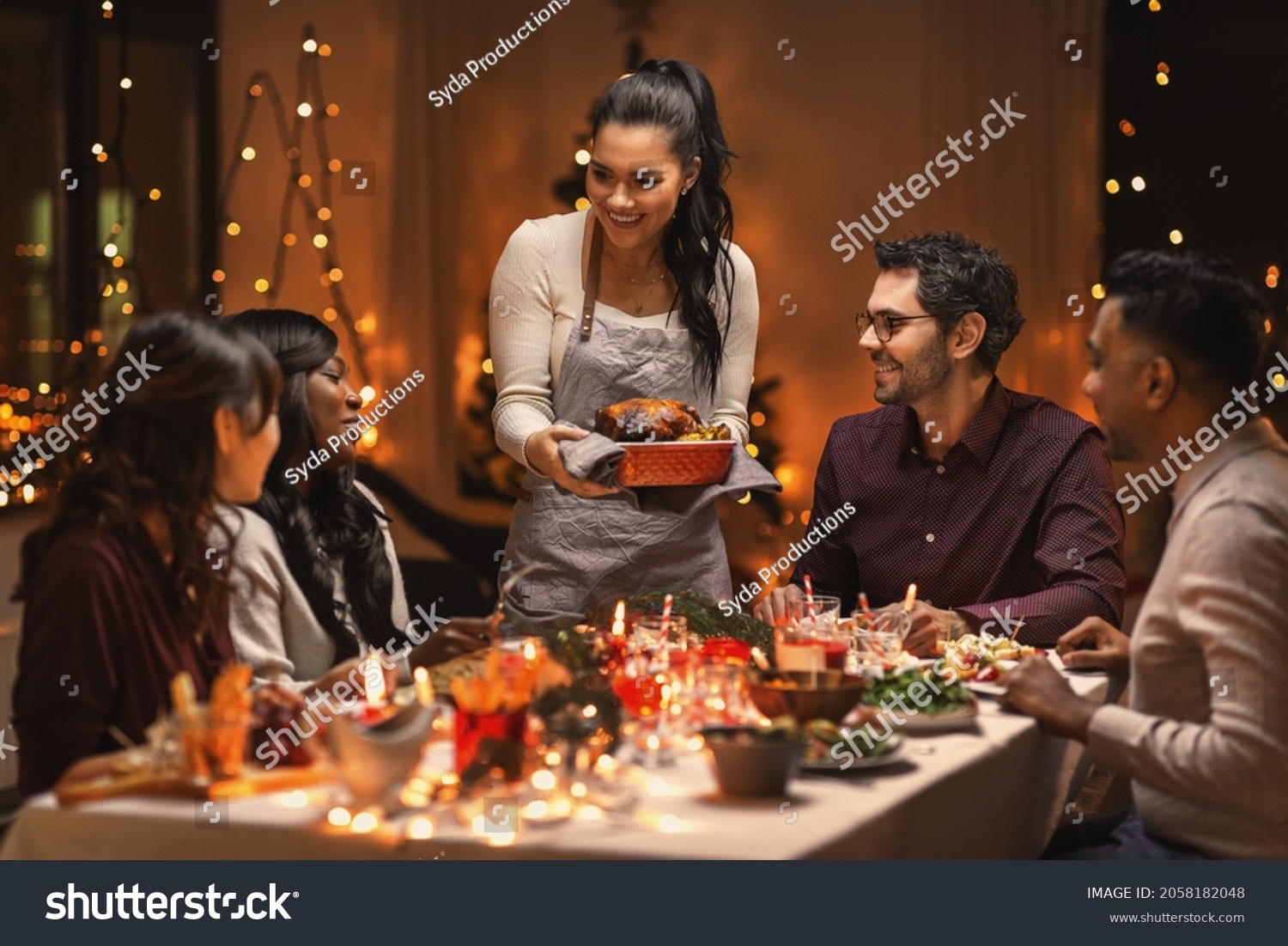 holidays and celebration concept - multiethnic group of happy friends having christmas dinner at home #2058182048