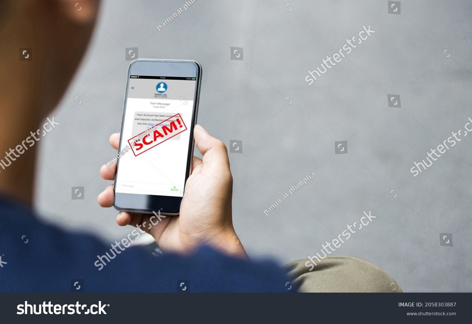 Text message SMS scam or phishing concept. Man hands using smart phone #2058303887
