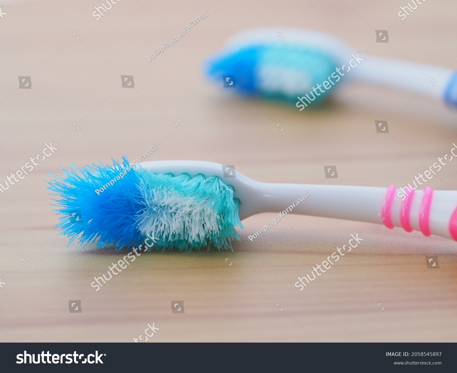 Comparison of the old and new toothbrushes showing different bristle conditions: time to change a new toothbrush #2058545897