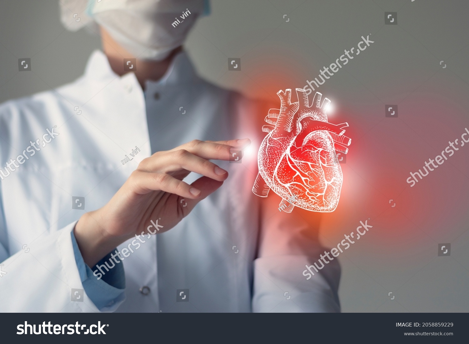 Female doctor touchstone virtual Heart in hand. Blurred photo, handrawn human organ, highlighted red as symbol of disease. Healthcare hospital service concept stock photo #2058859229