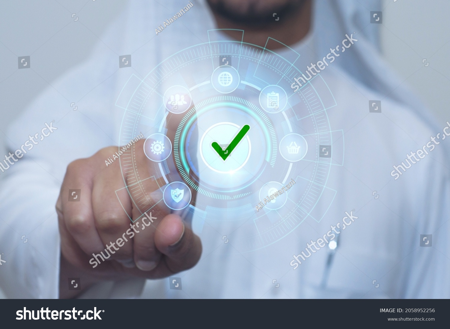 Saudi man indicates with his finger. E services touch screen with correct choice #2058952256