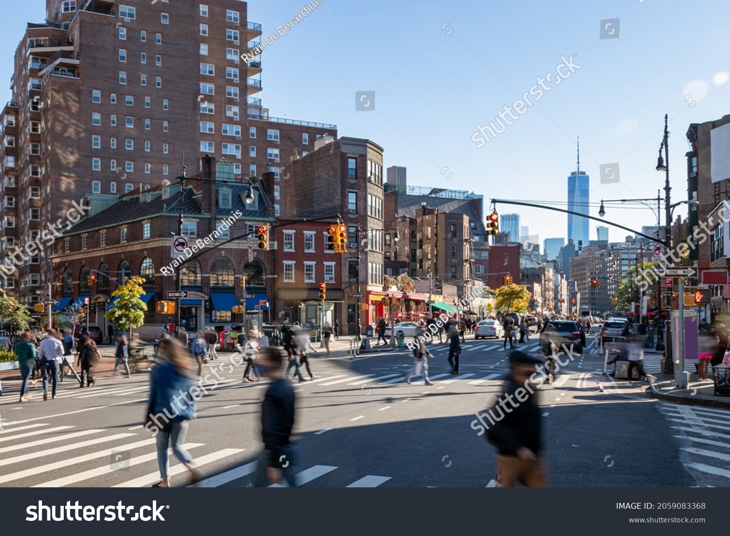 Crowds of people walking across a busy intersection on 7th Avenue in the West Village neighborhood of New York City NYC #2059083368