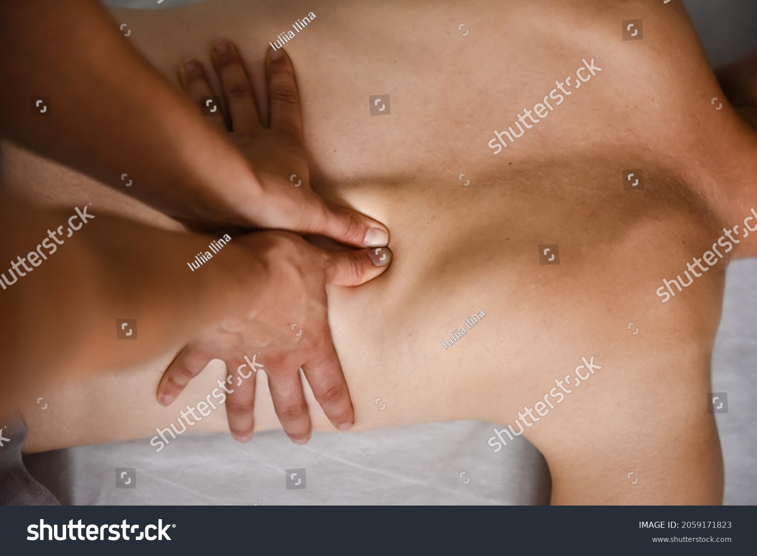 Female energy massage shiatsu relaxing and care treatment for body and mindfull health gentle woman arms doing back close up #2059171823