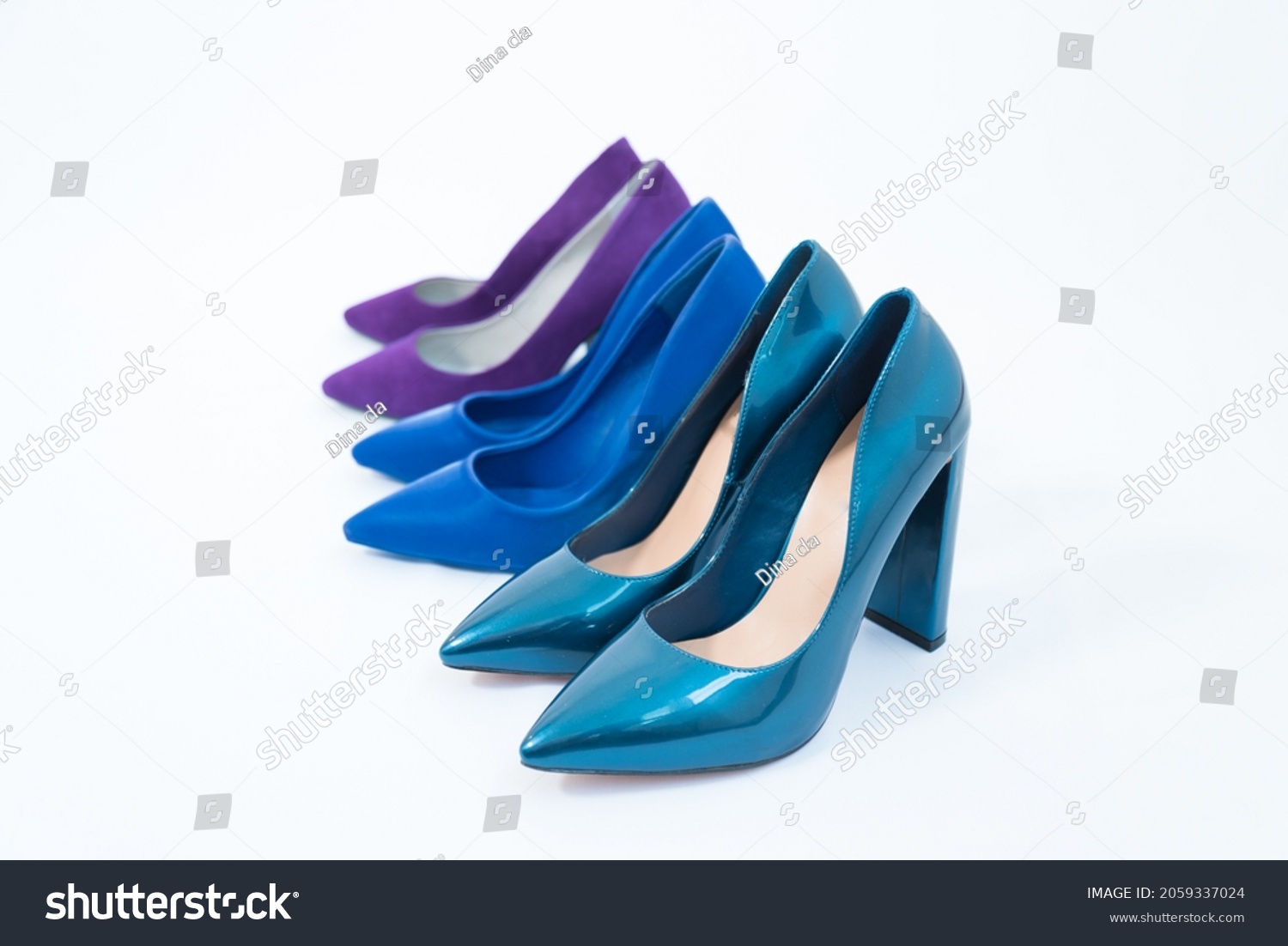 Three pairs of blue women's shoes. High-heeled shoes. One pair of thin heels, stiletto heels. The second pair has a stable, wide heel. Fashionable stylish shoes. Variety of colors #2059337024